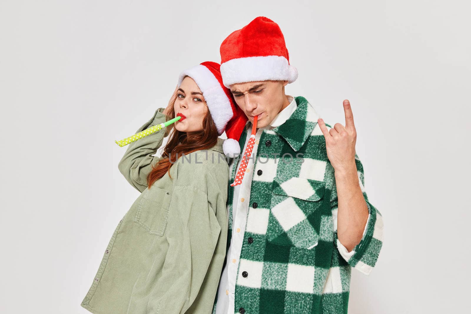 Cheerful man and woman holiday gifts New Year friendship hug fashion by SHOTPRIME