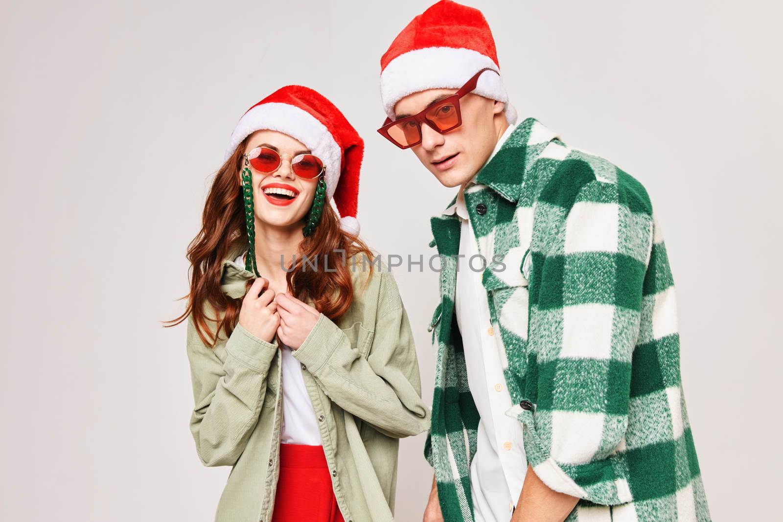 cheerful young couple wearing sunglasses New Years holiday together. High quality photo