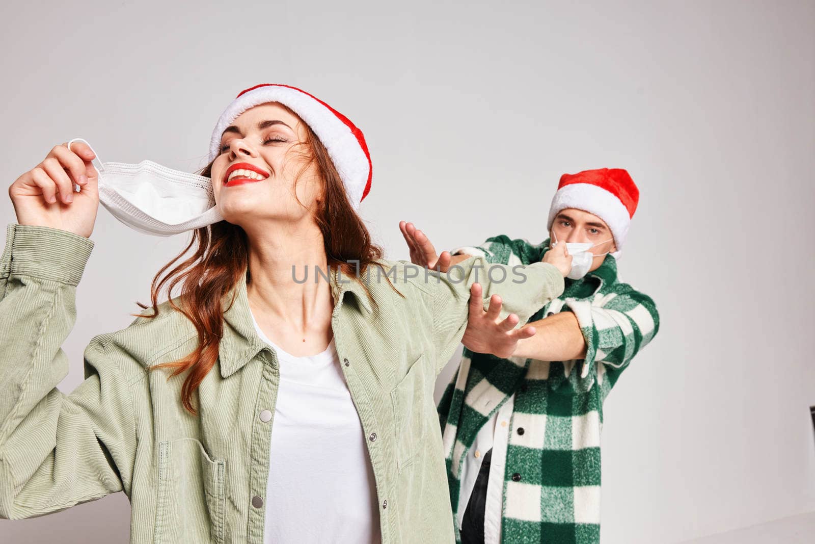 man and woman wearing medical masks Christmas New Year Studio celebration. High quality photo