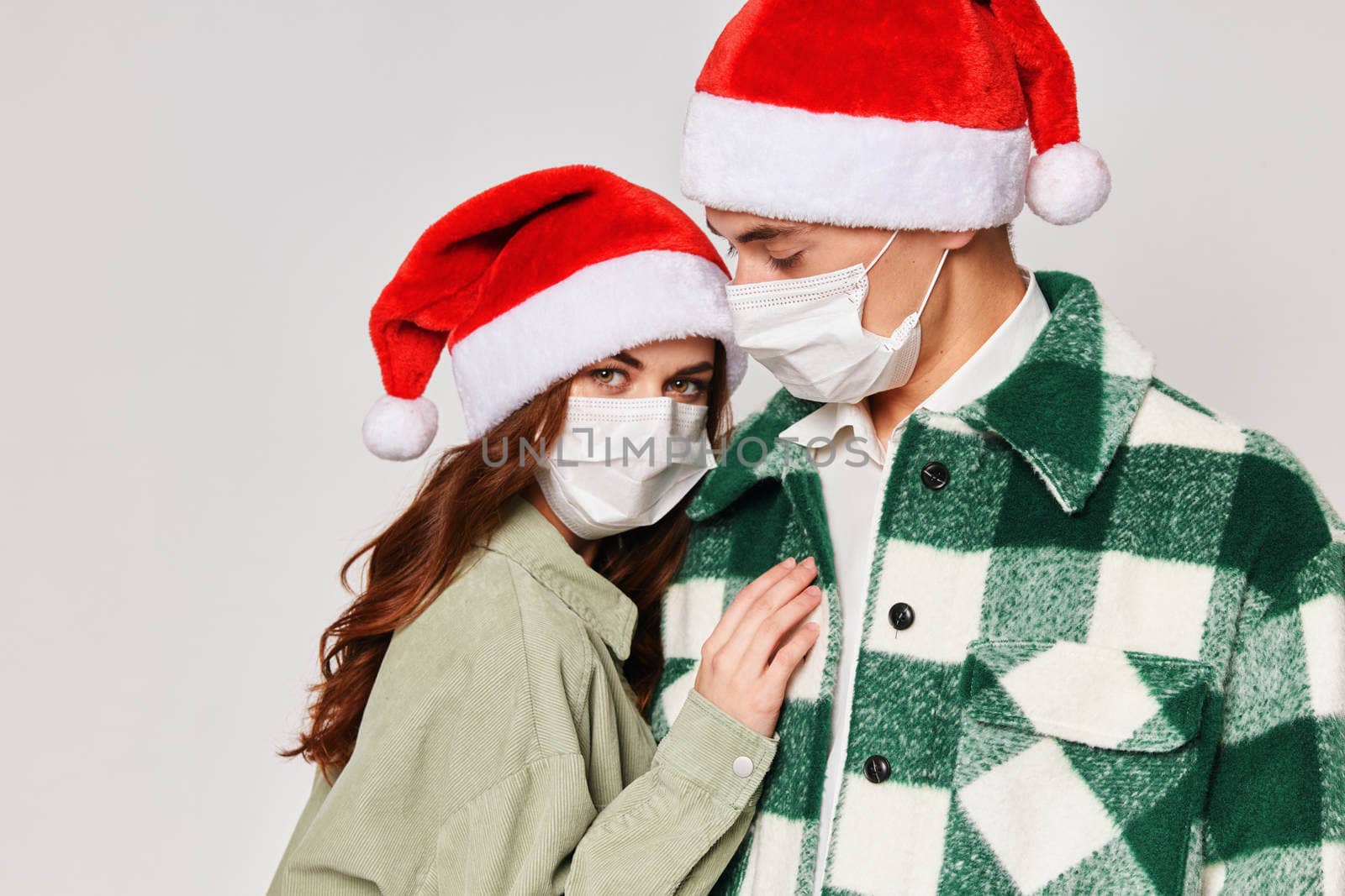 man and woman in medical masks protection hugs together friendship new year holiday by SHOTPRIME