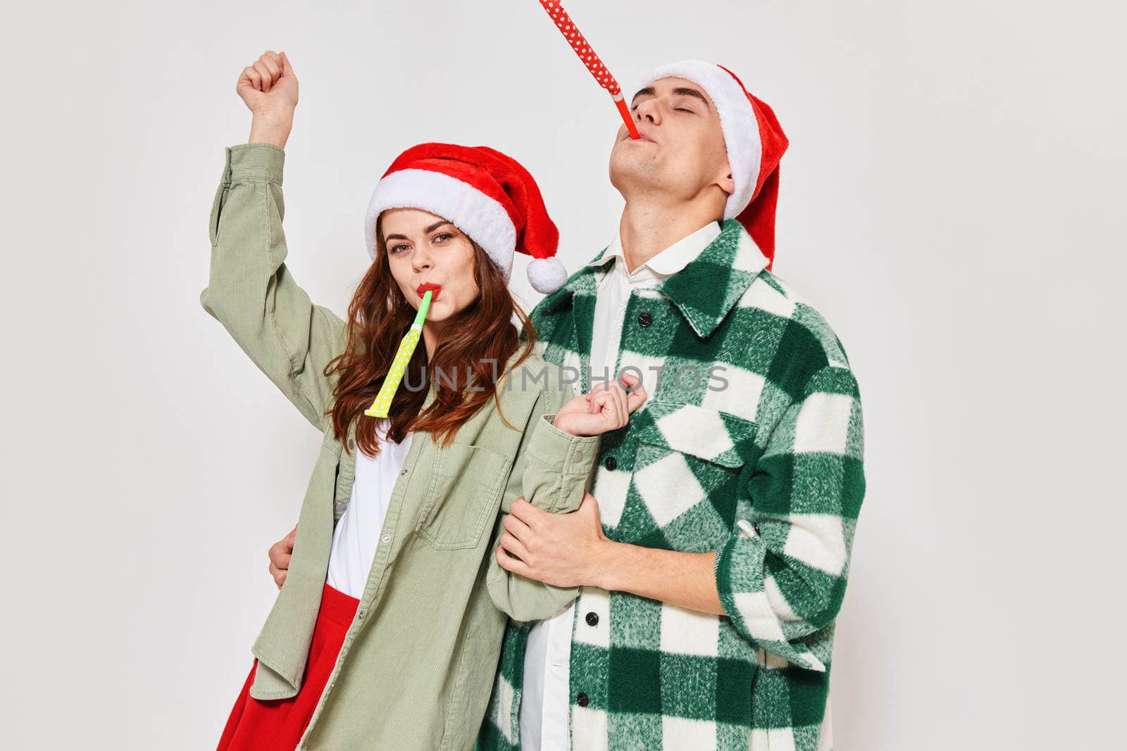Man and woman in New Year's clothes Santa hat holiday fun emotions Friendship gray background. High quality photo