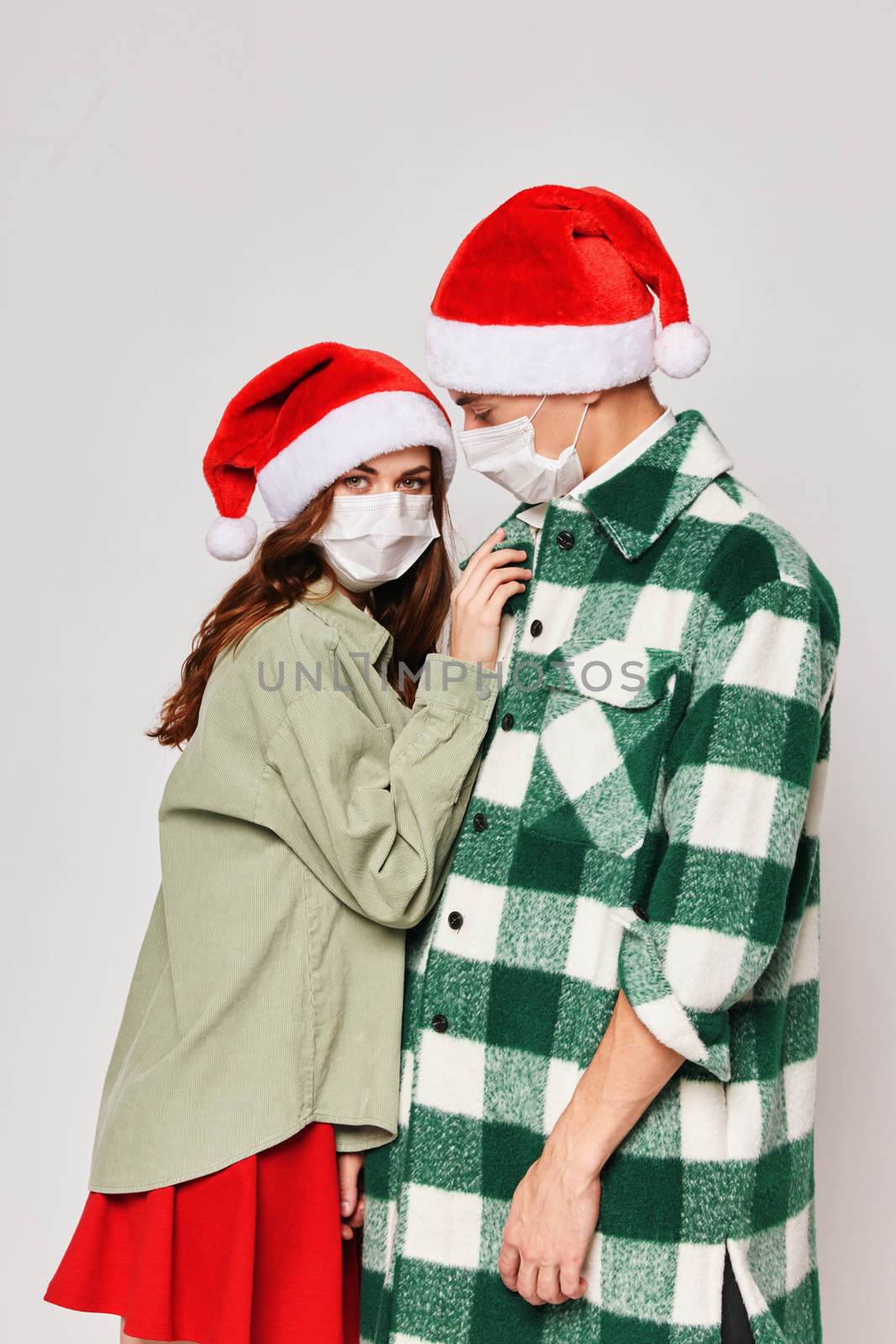 Man and woman New Years medical masks protection hugs care. High quality photo