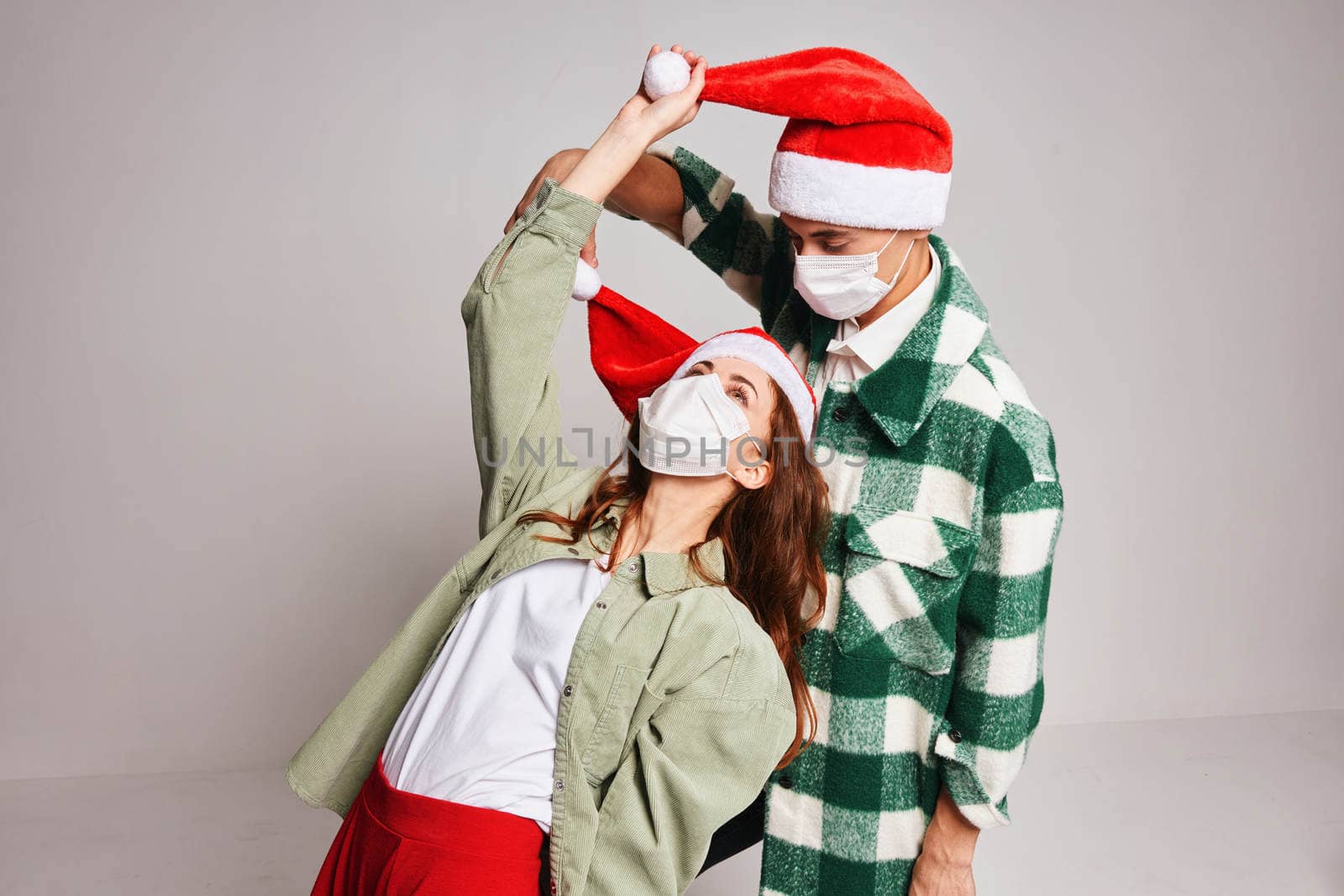 Cute young couple new year clothes holiday lifestyle medical masks by SHOTPRIME