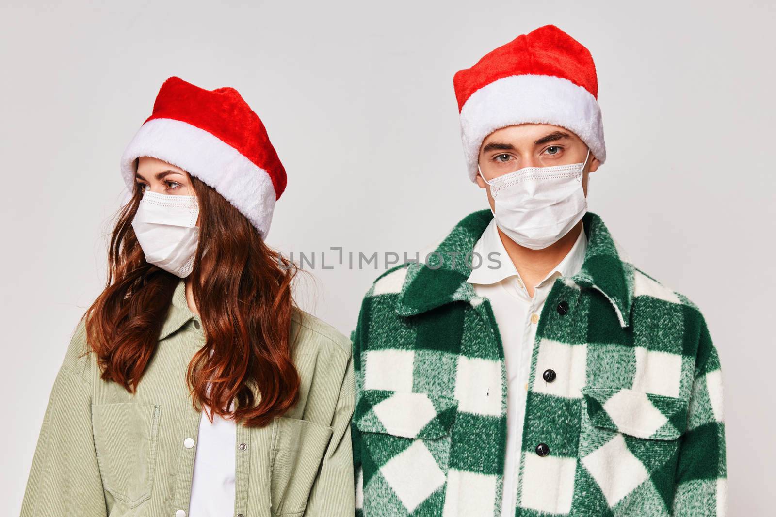 Man and woman in medical masks New Years holiday friendship together by SHOTPRIME