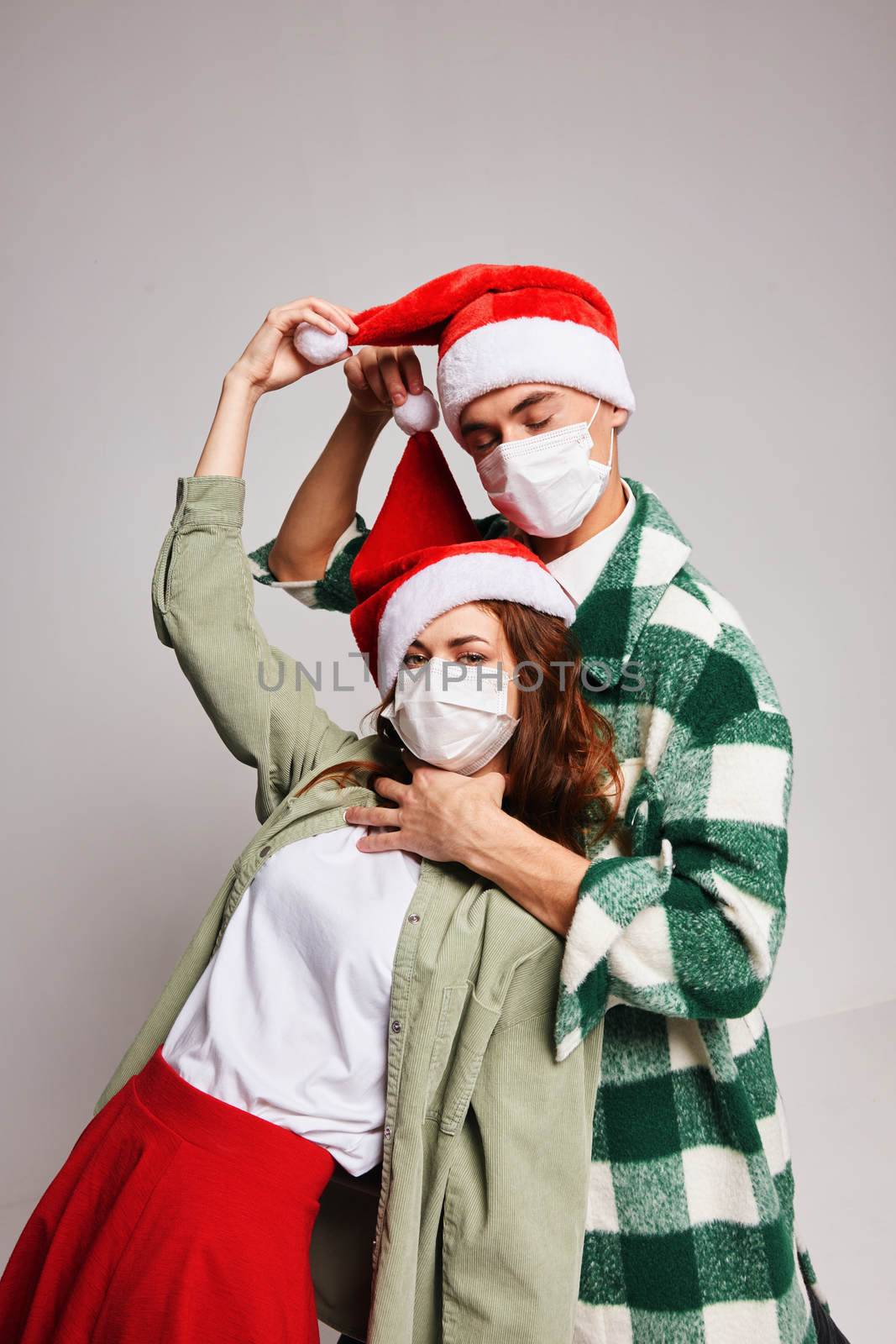 Man and woman New Years isolation quarantine medical masks celebration. High quality photo