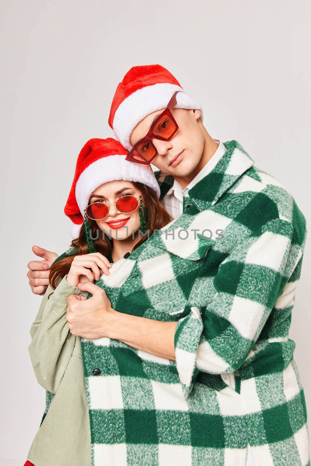 A man hugs a woman young couple New Years sunglasses holiday friendship by SHOTPRIME