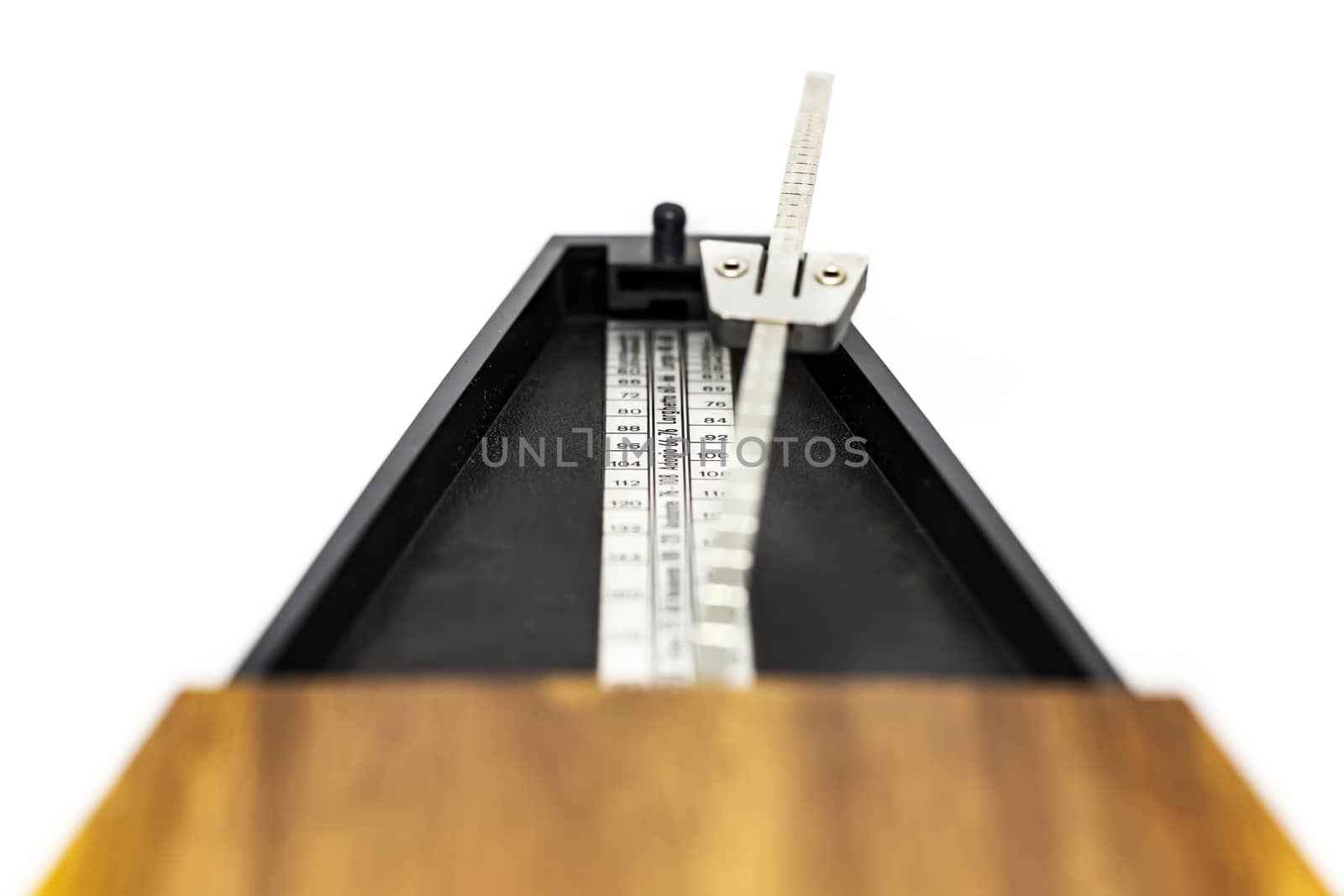 Detail of the pendulum of a classic metronome. Rhythm measurement tool. Mechanical movement without electricity