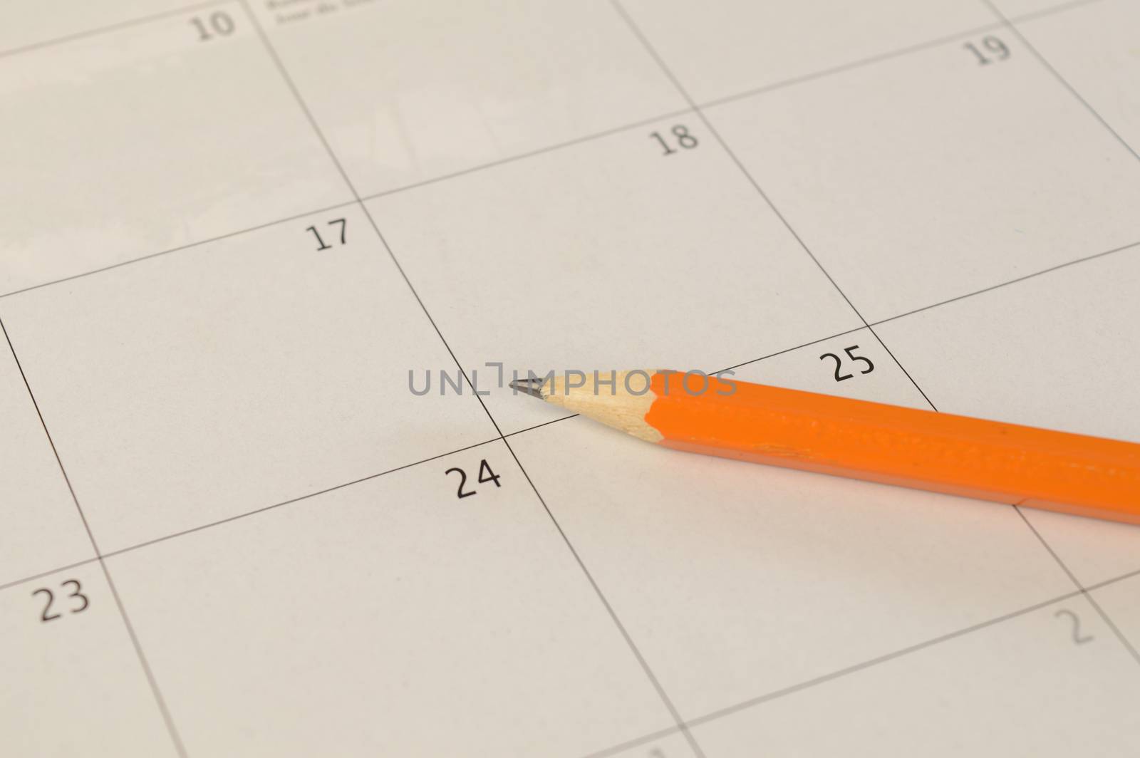A closeup of a pencil and calendar to save important dates and memos.