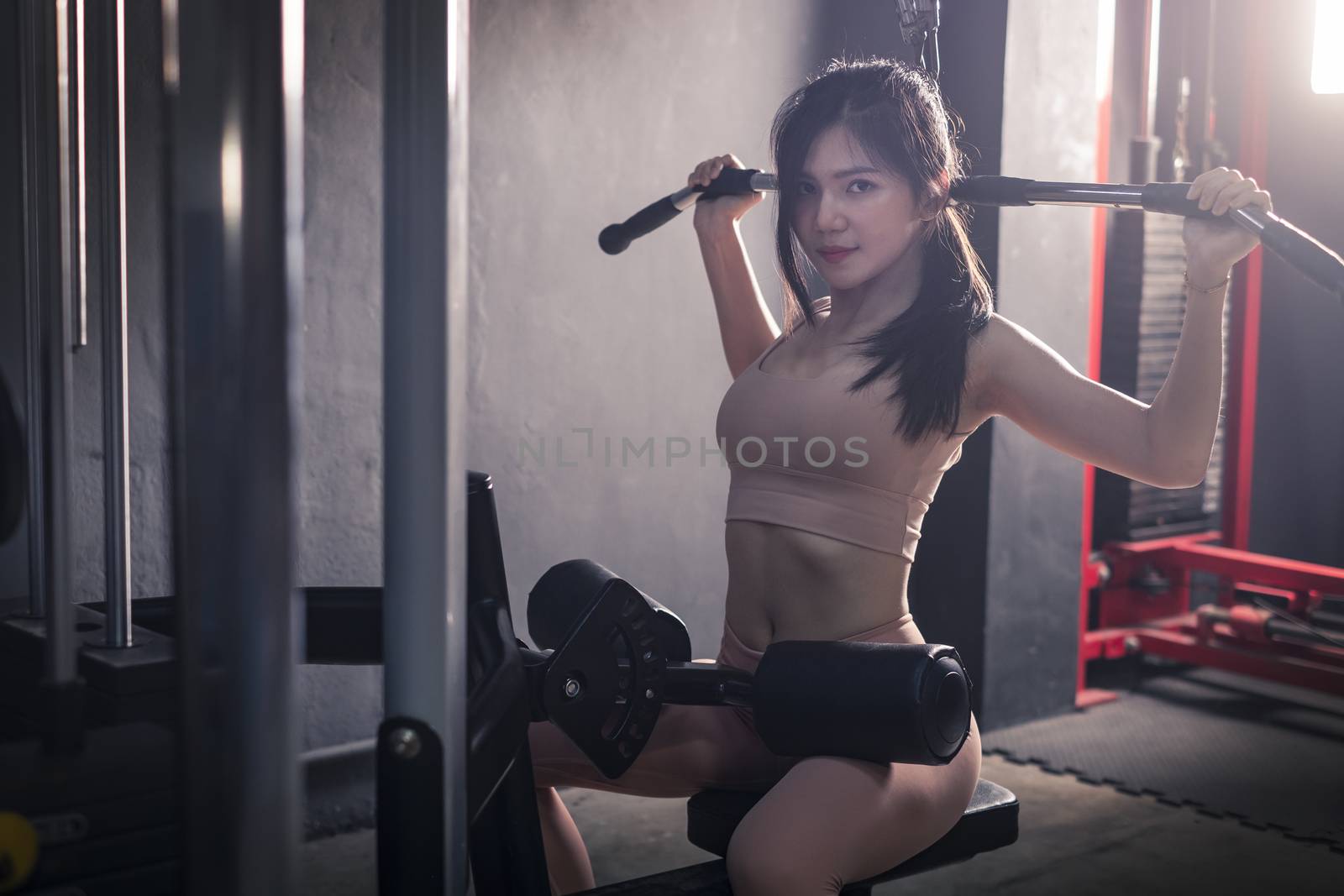 young fitness woman workout with exercise-machine in gym