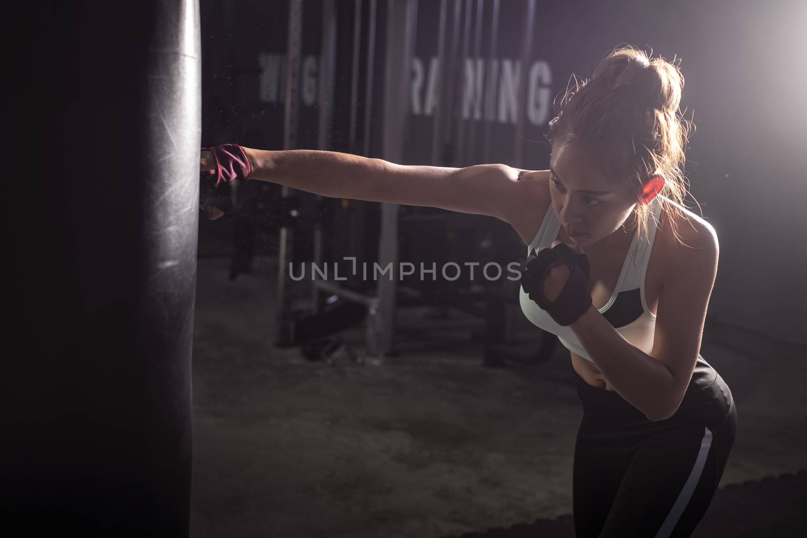 Fitness girl doing  boxing training in sport gym by Surasak