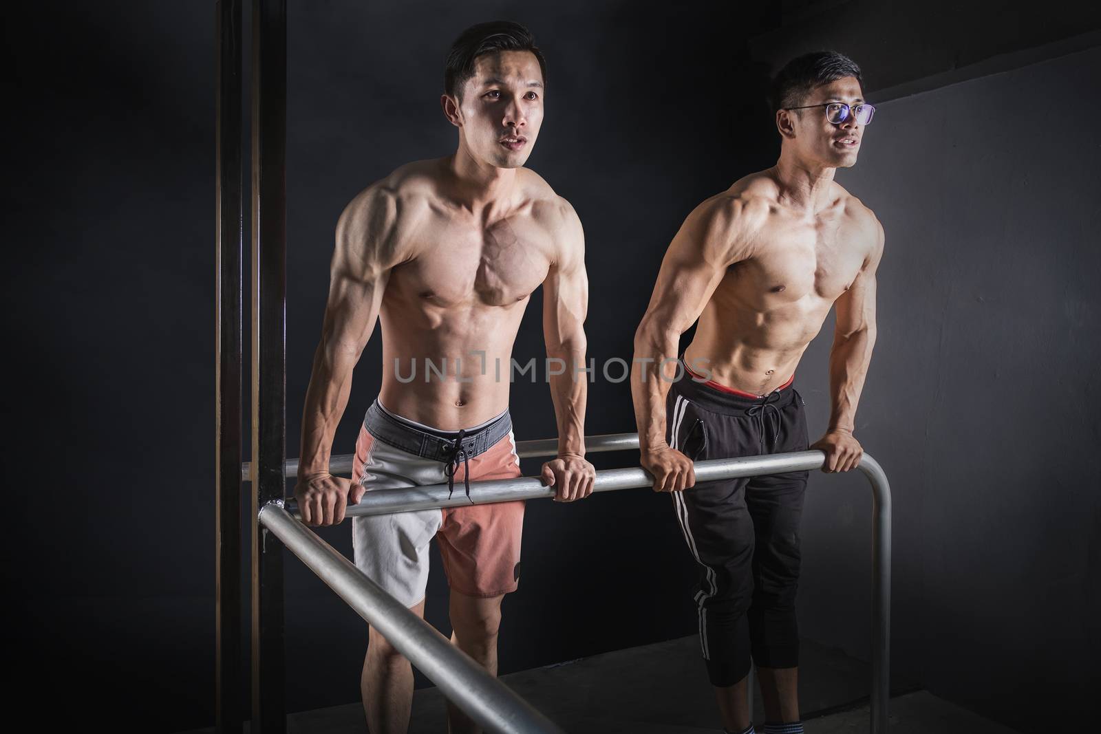  bodybuilder workout in fitness gym. by Surasak