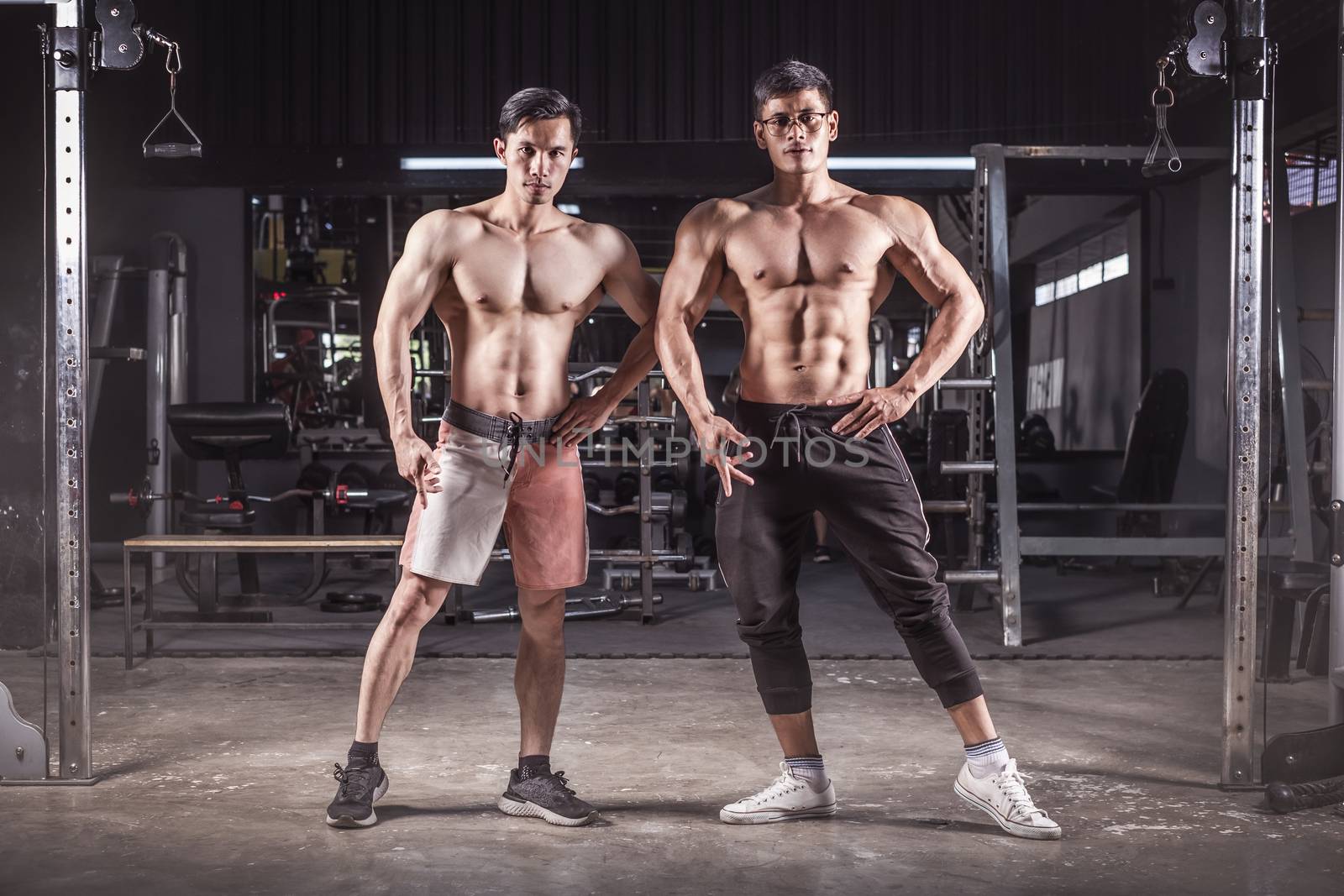  bodybuilder workout in fitness gym. by Surasak