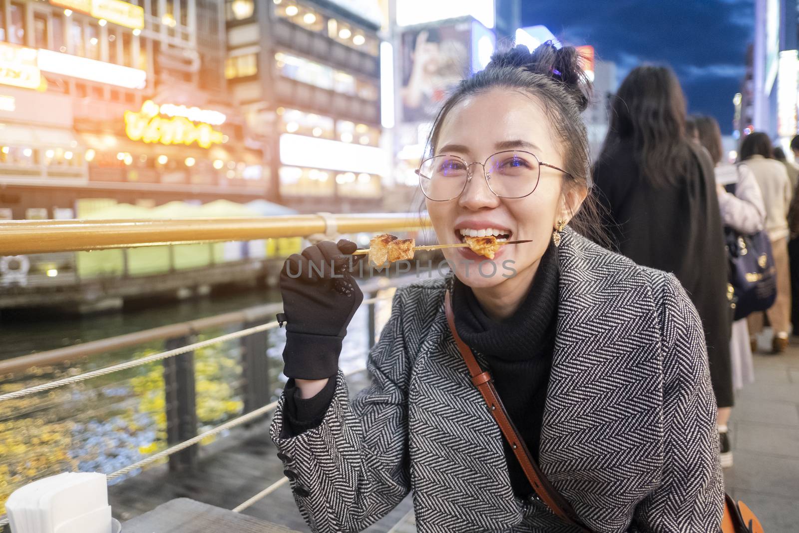 Young woman tourists enjoy eating street food in walking at stre by Surasak