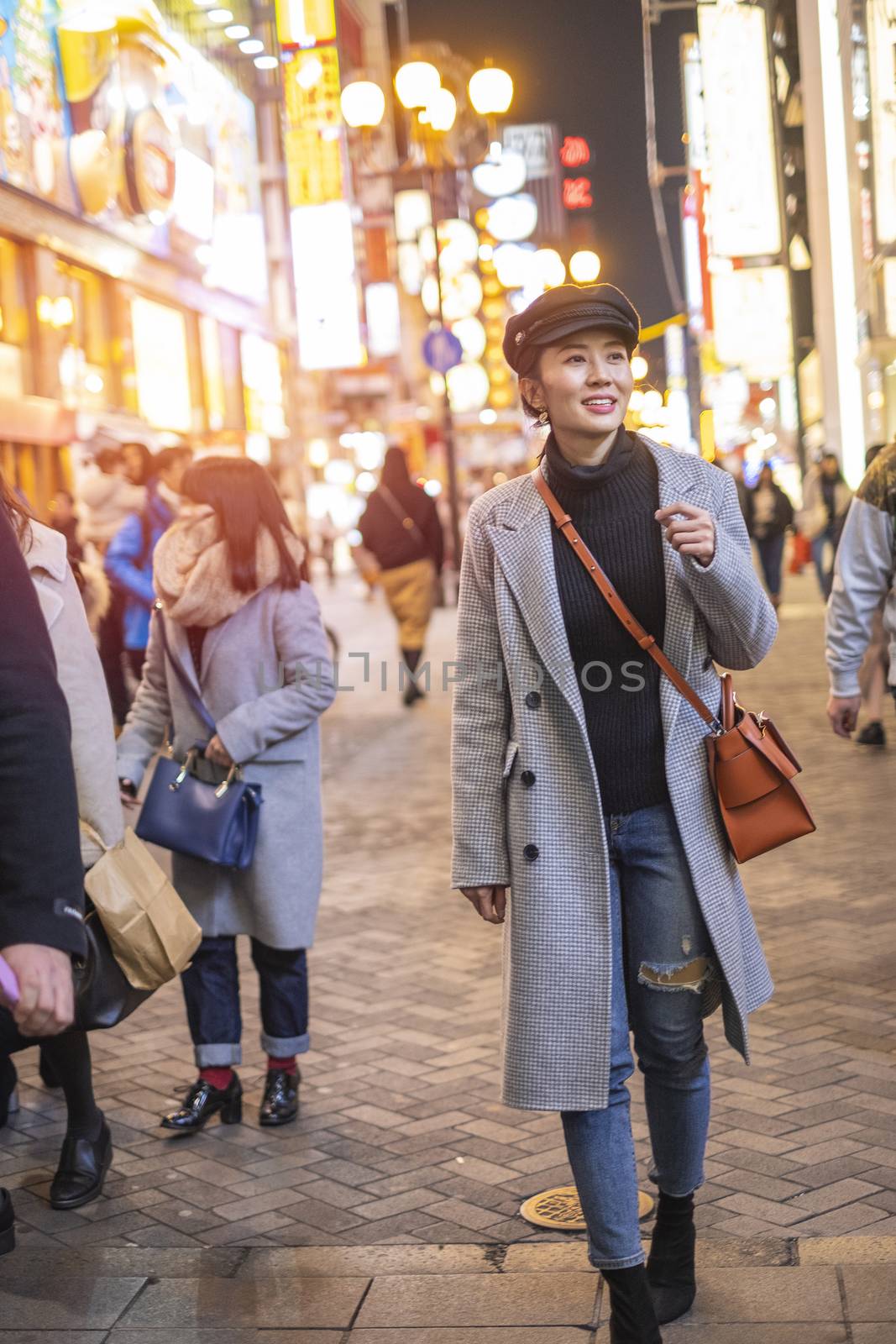 Beautiful smiling woman tourists traveling in walking at street  by Surasak