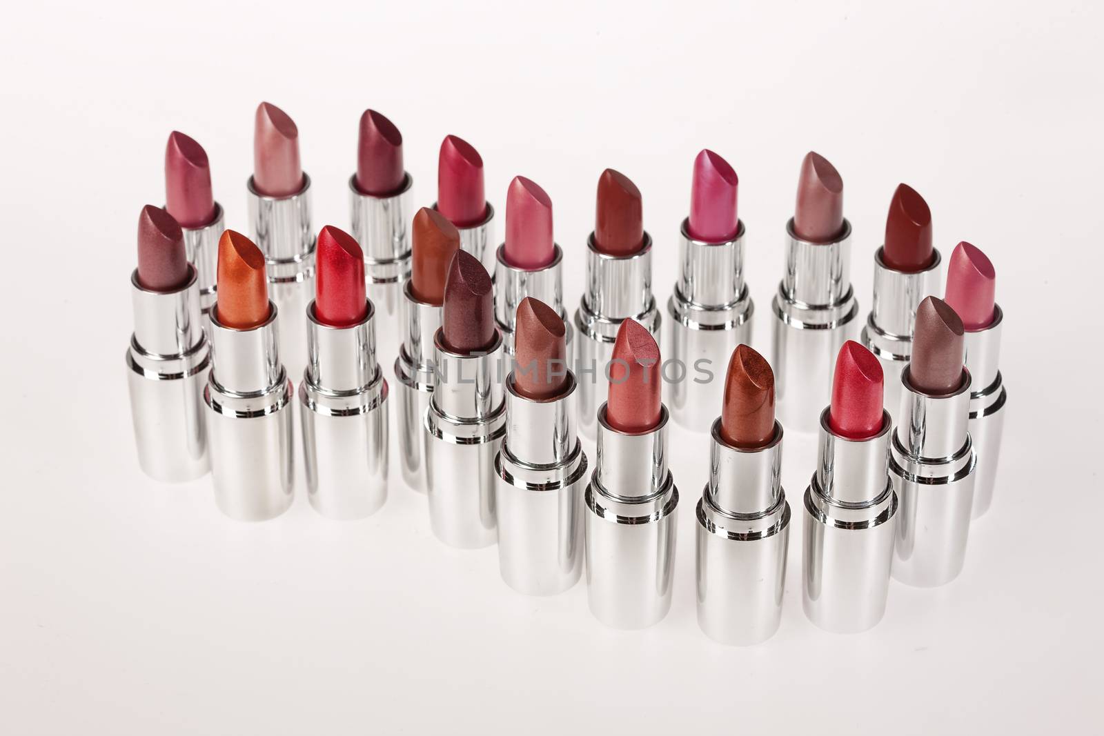 Tubes with different kinds of lipstick on studio background