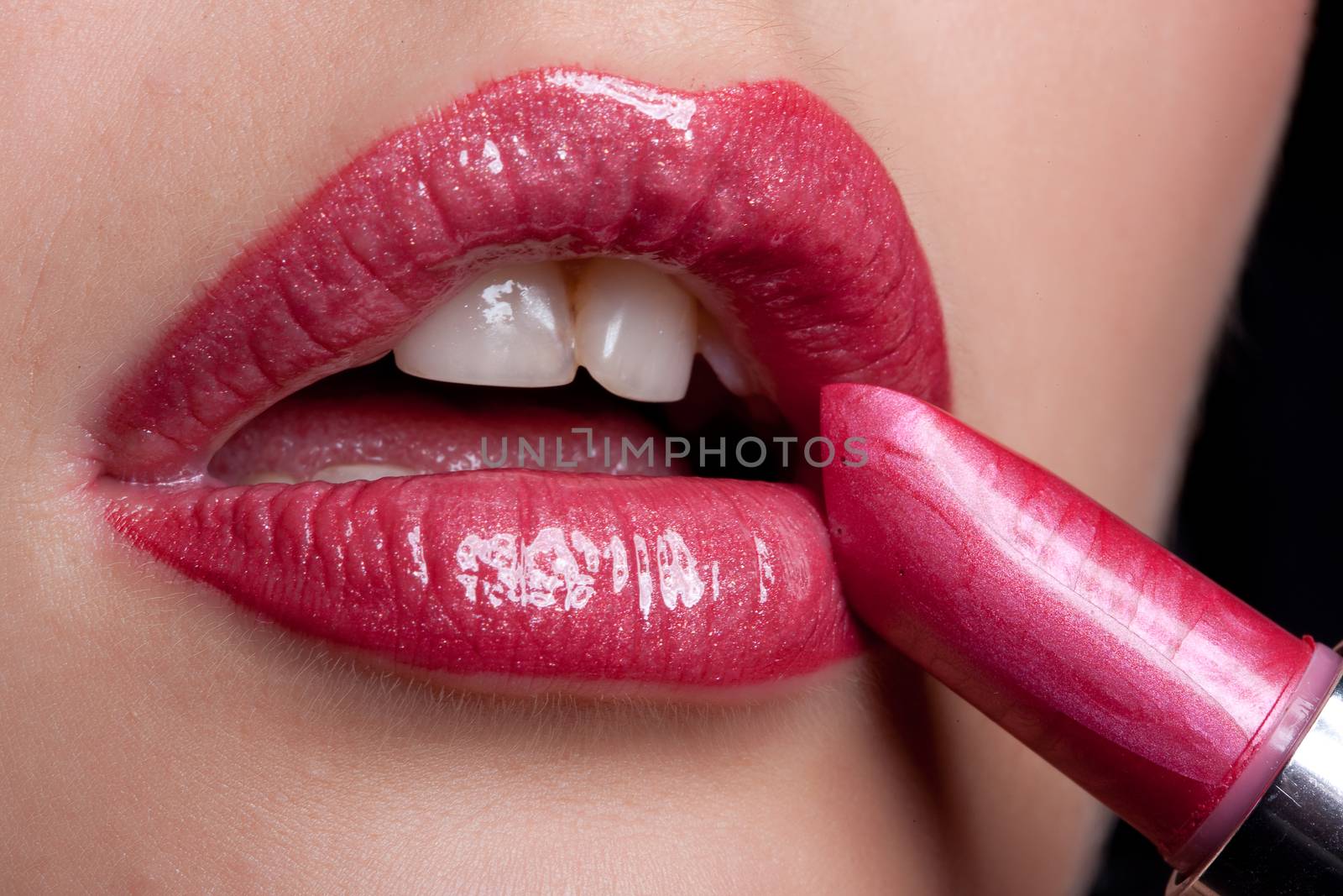 Young Woman Applying Cosmetics by Fotoskat