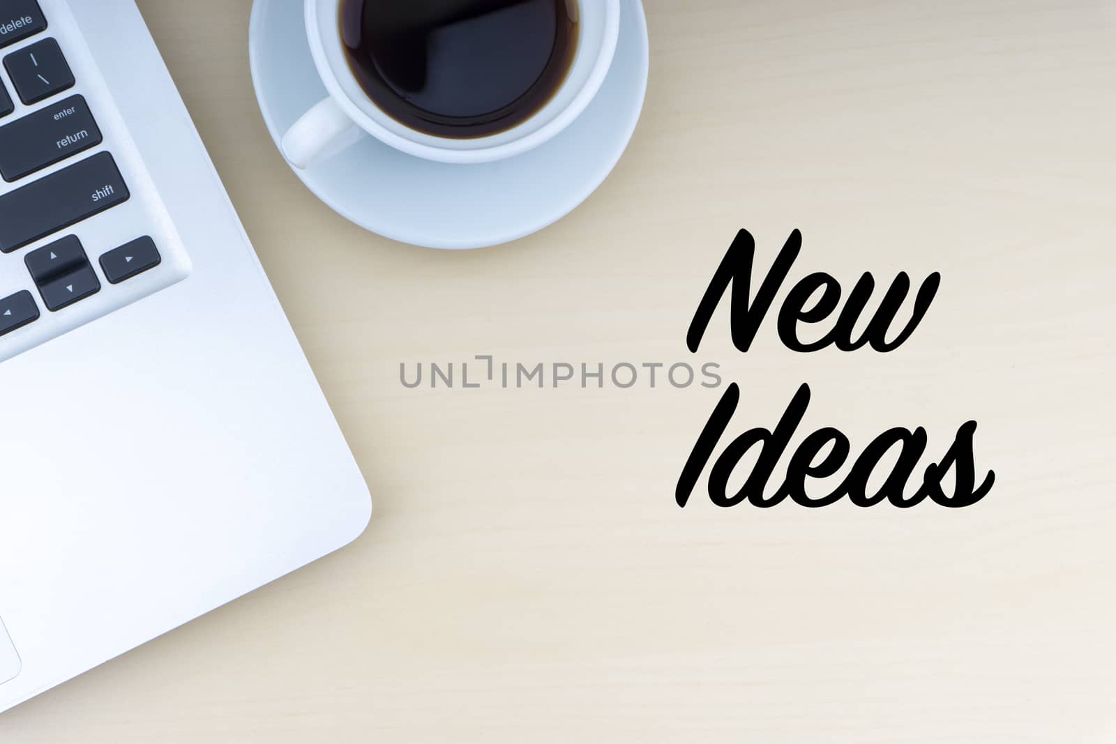 NEW IDEAS text with laptop and cup of coffee on wooden background by silverwings