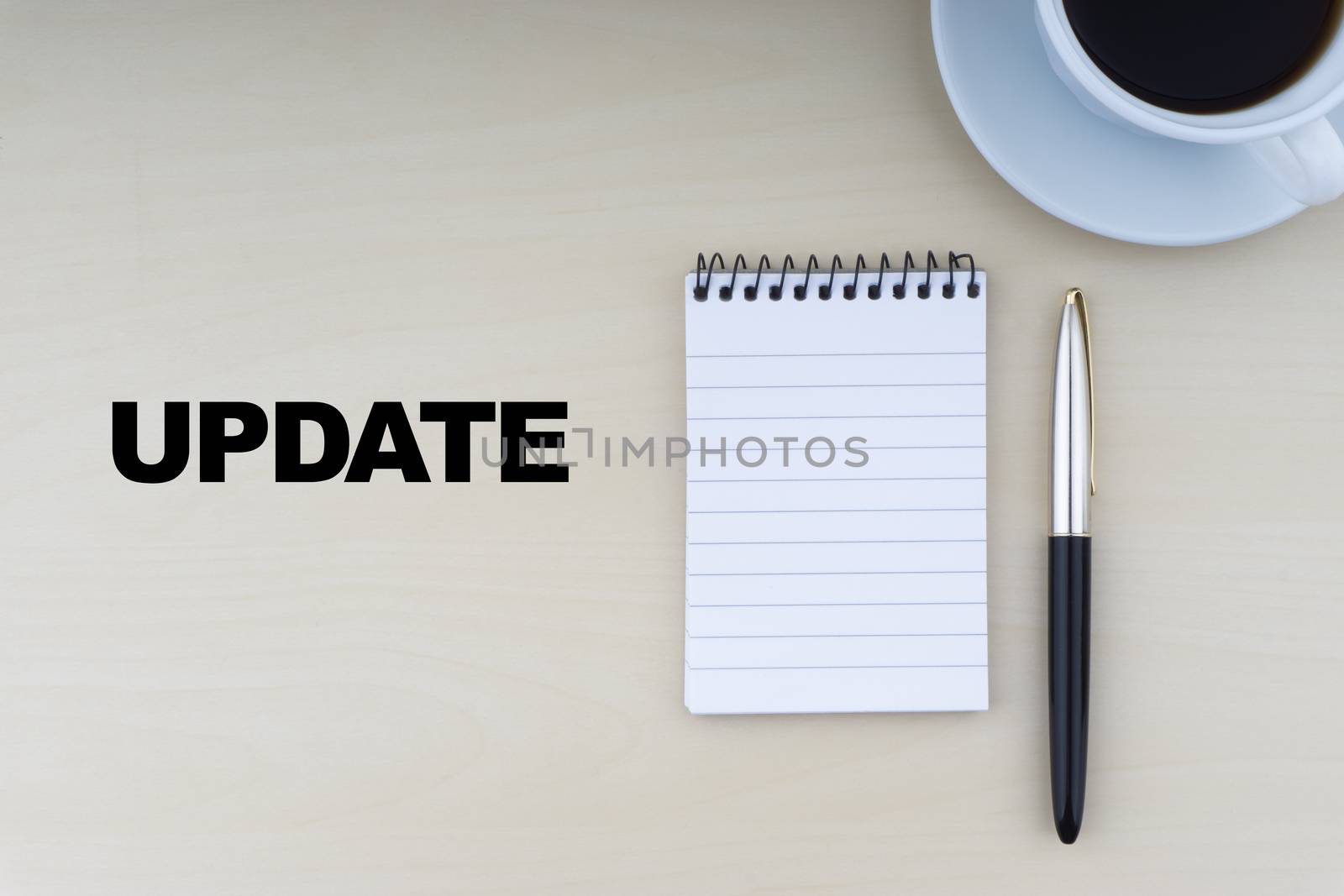 UPDATE text with fountain pen, notepad and cup of coffee on wooden background by silverwings