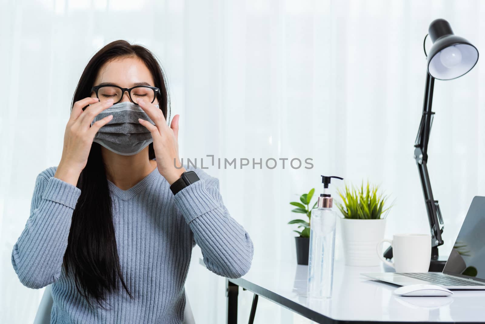 Asian young business beautiful woman during wearing face mask protective working from home office with laptop computer desk he quarantines disease coronavirus or COVID-19 virus