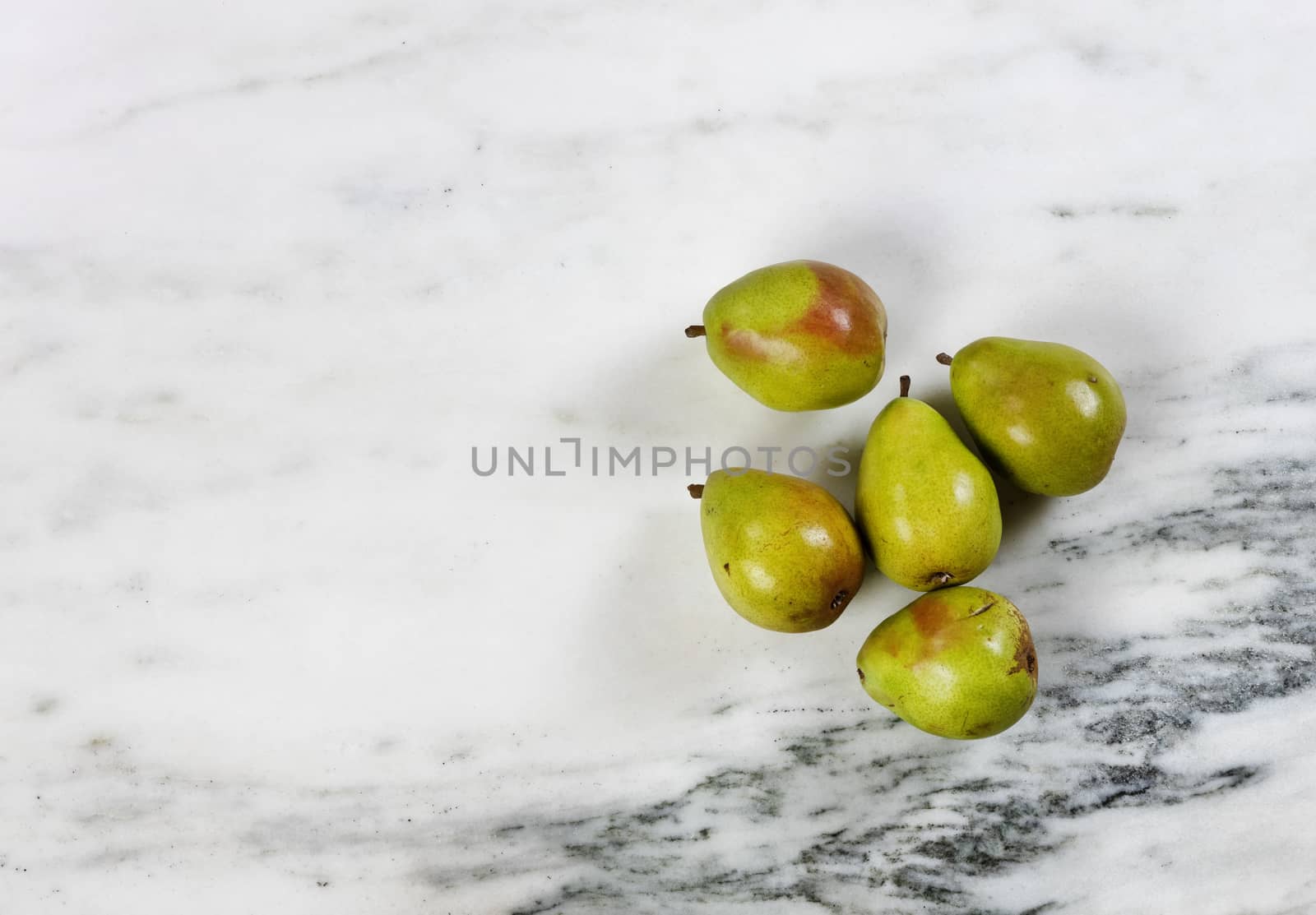 Fresh organic raw pears on marble stone table in top view format by tab1962