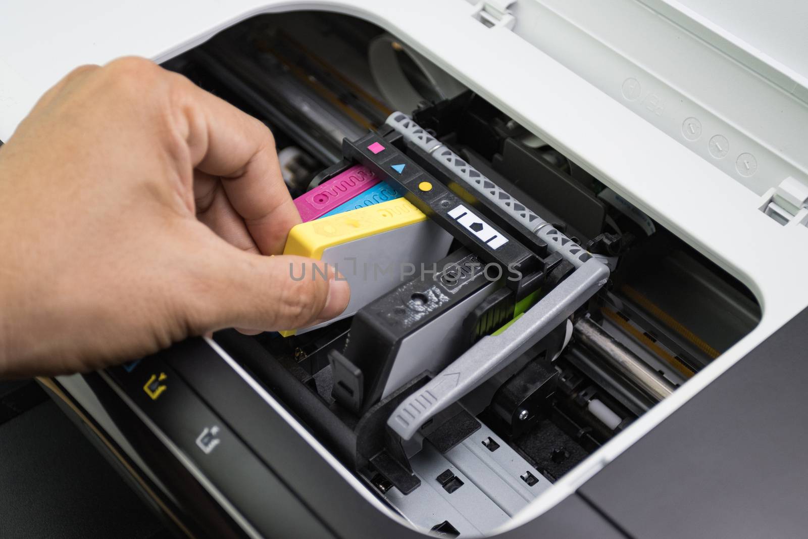 Technicians are install setup the ink cartridge of a inkjet printer the device of office automate for printing