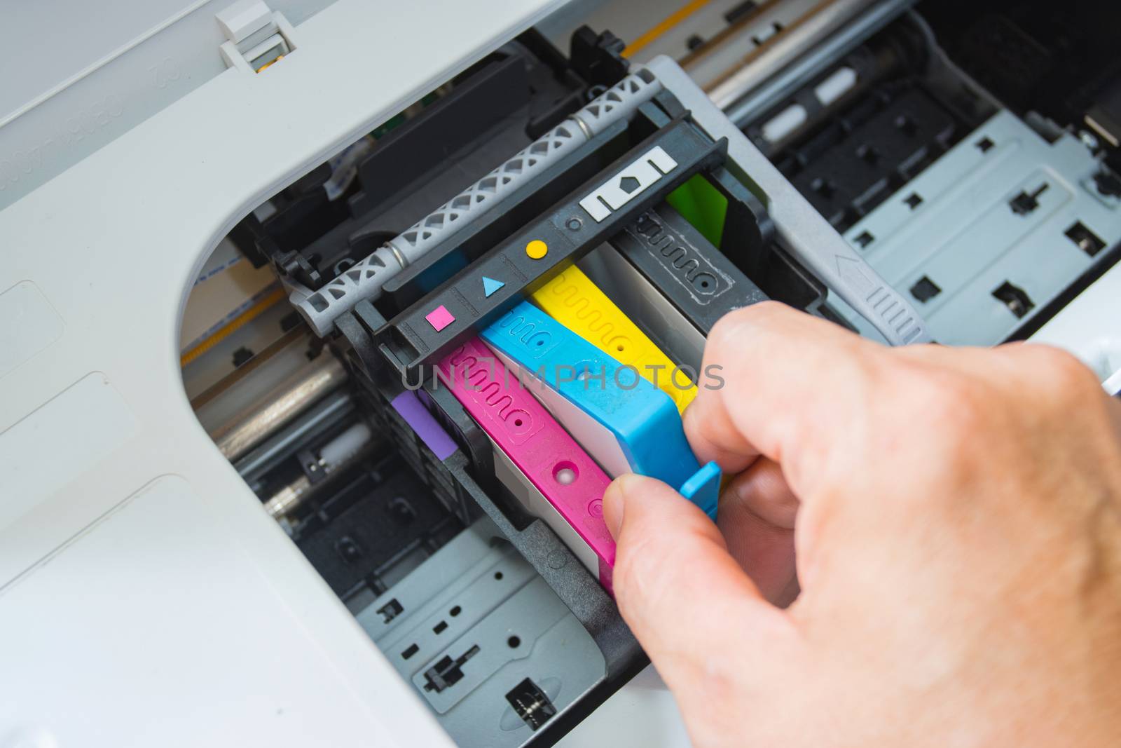 Technicians are install setup the ink cartridge of a inkjet printer the device of office automate for printing