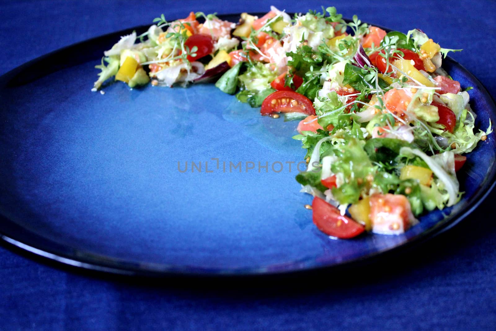 Vegetarian food with fresh vegetables on a blue background.Texture or background