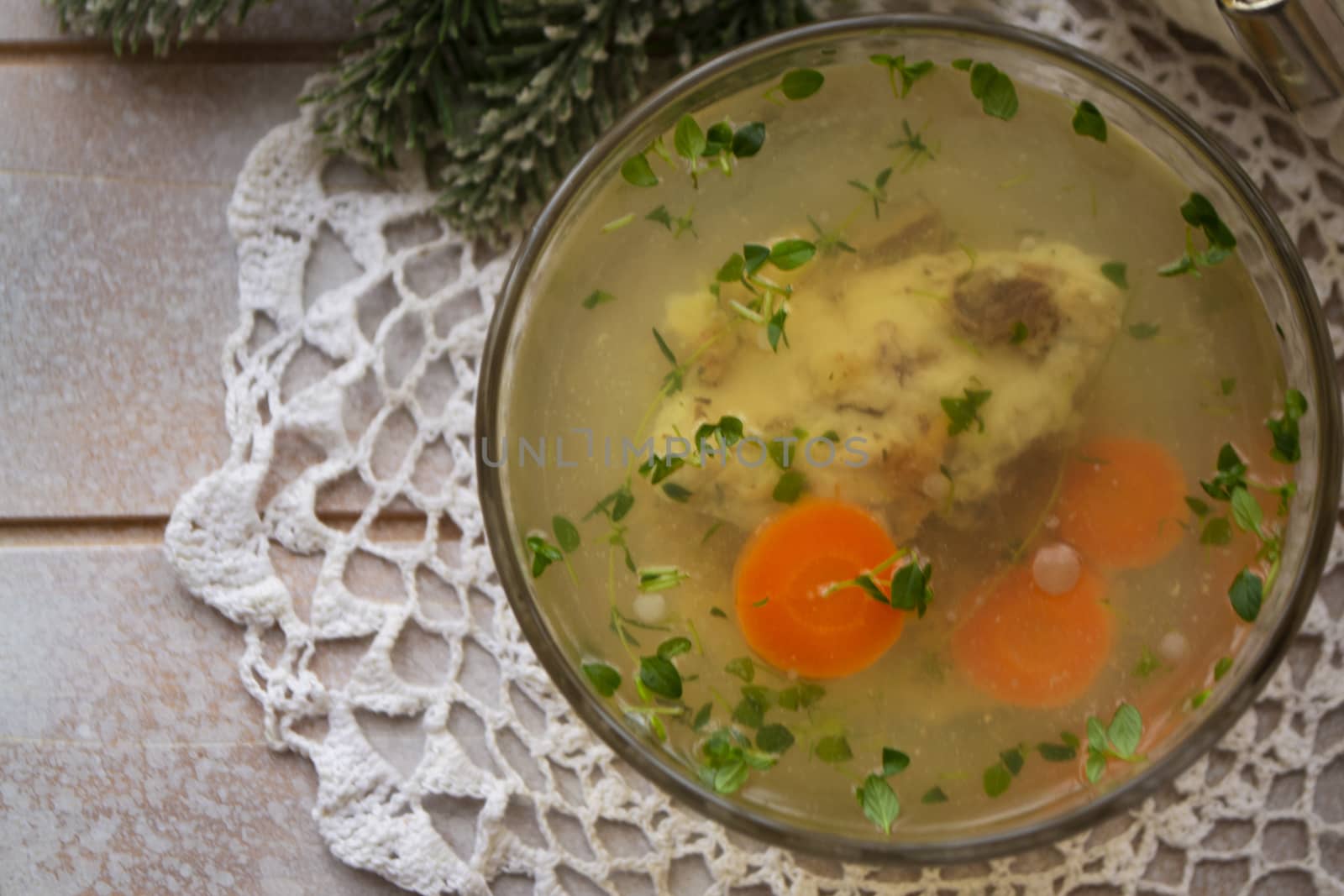 bowl of carp in jelly with carrot and parsley as traditional belarusian dish on christmas table, flat lay