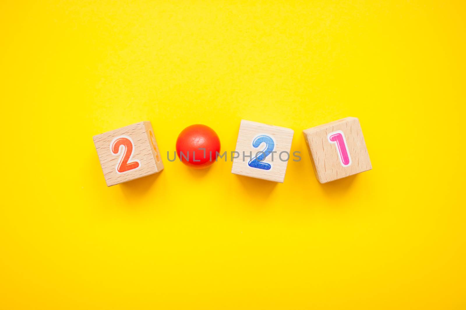 Numbers 2021 from children's cubes on a bright yellow background. New Year by malyshkamju