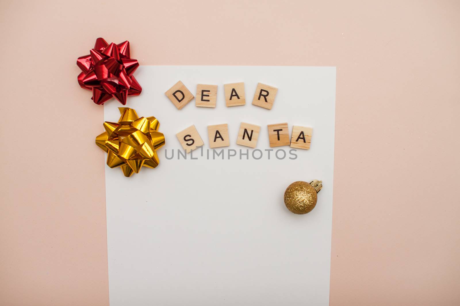 Inscription from wooden blocks dear santa on a white blank sheet of paper. New Year's wish list. Letter to Santa Claus