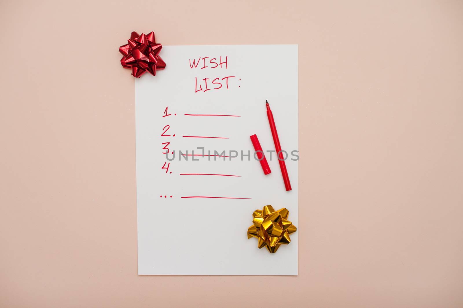 Inscription in red felt-tip pen wish list on a white blank sheet of paper. New Year's wish list. Letter to Santa Claus