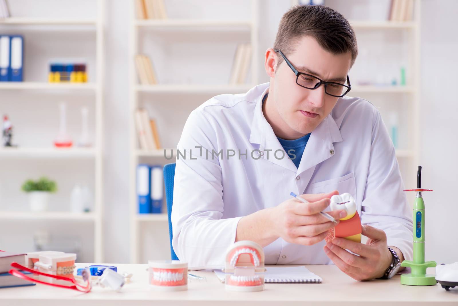 Dentist working teeth implant in medical lab