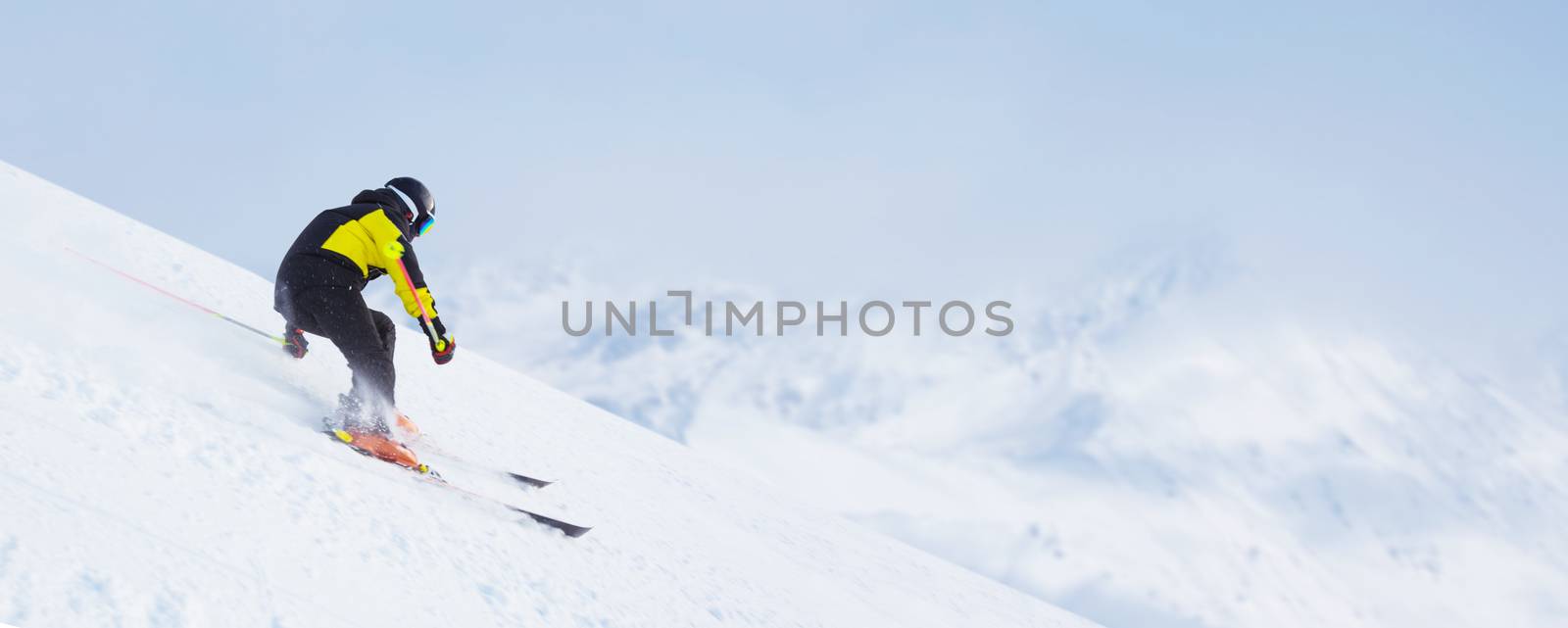 Skier man skiing downhill in high mountains piste, Solden, Tyrol, Austria