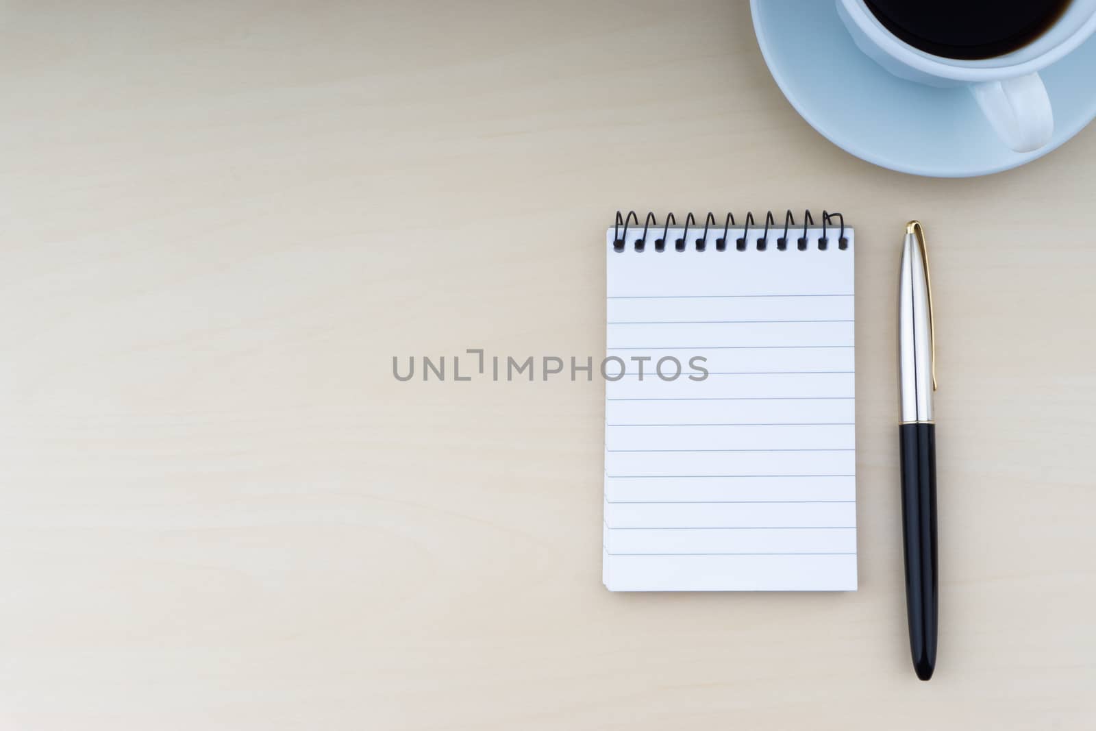 Fountain pen, notepad and cup of coffee on wooden background. Business and copy space concept. by silverwings