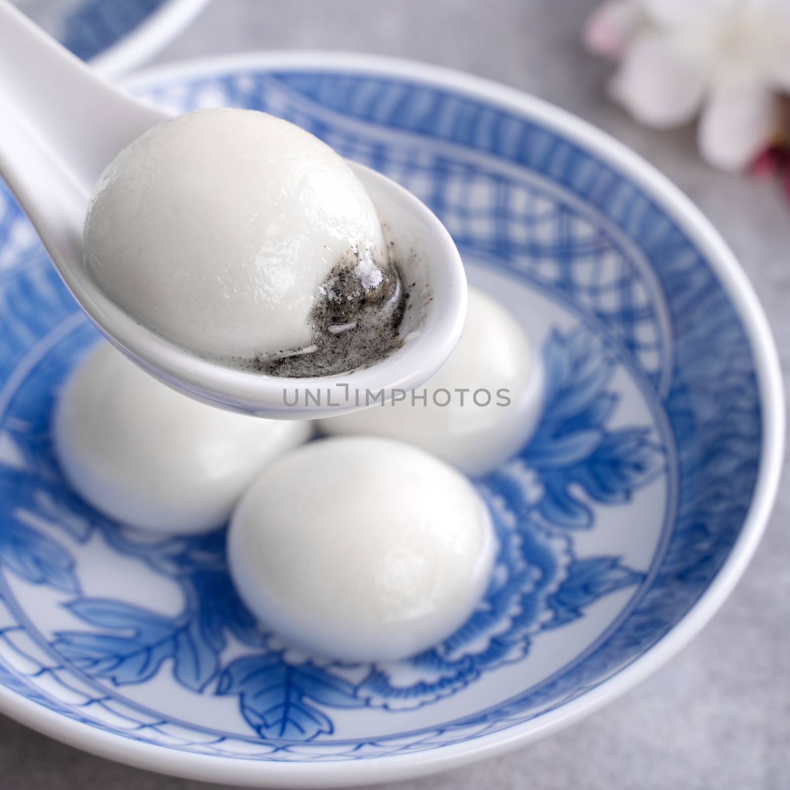 Close up of big tangyuan yuanxiao (glutinous rice dumpling balls) for Winter Solstice festival food on gray table background.
