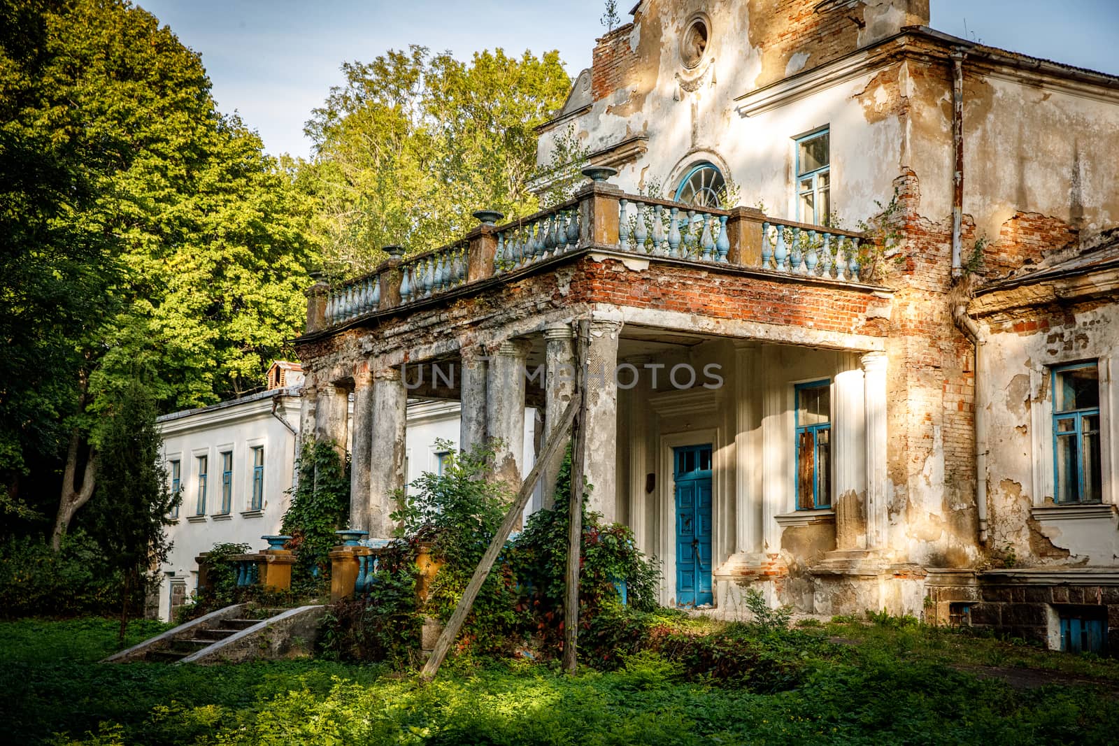 Old abandoned manor in the forest. Ruined house in nature