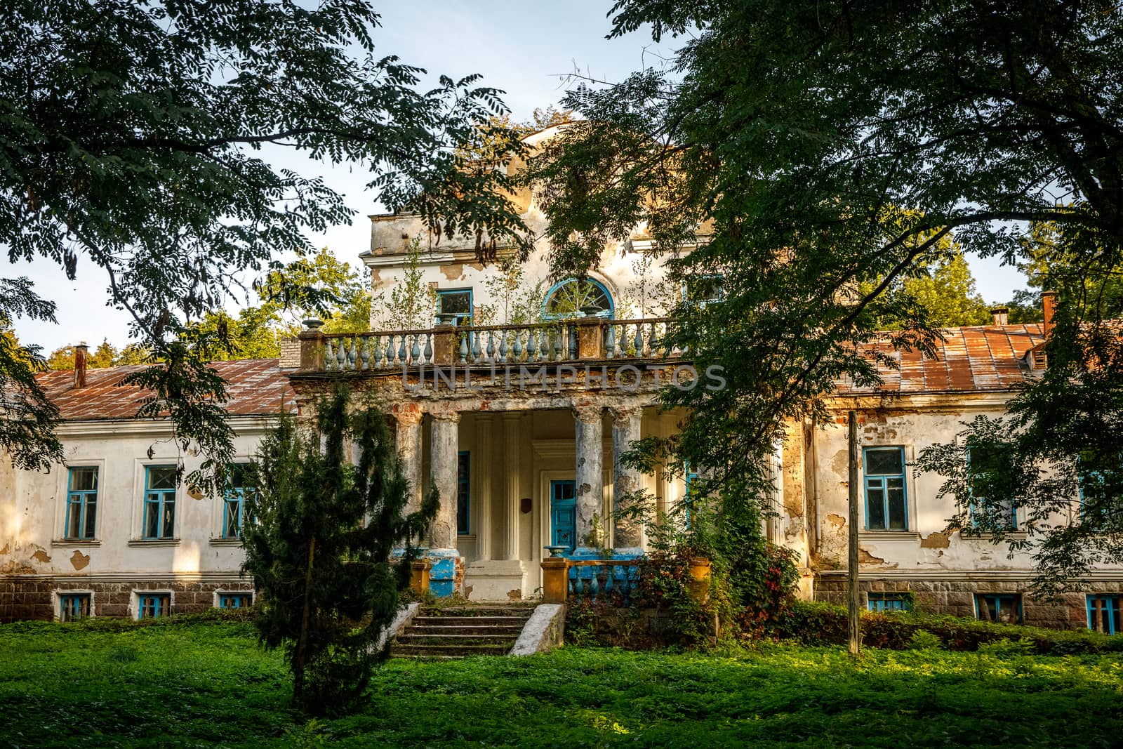 Old abandoned manor in the forest. Ruined house in nature