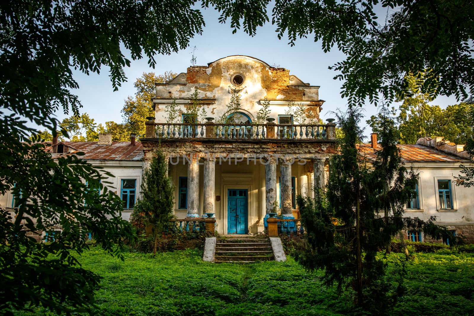 Old abandoned manor in the forest. Ruined house in nature