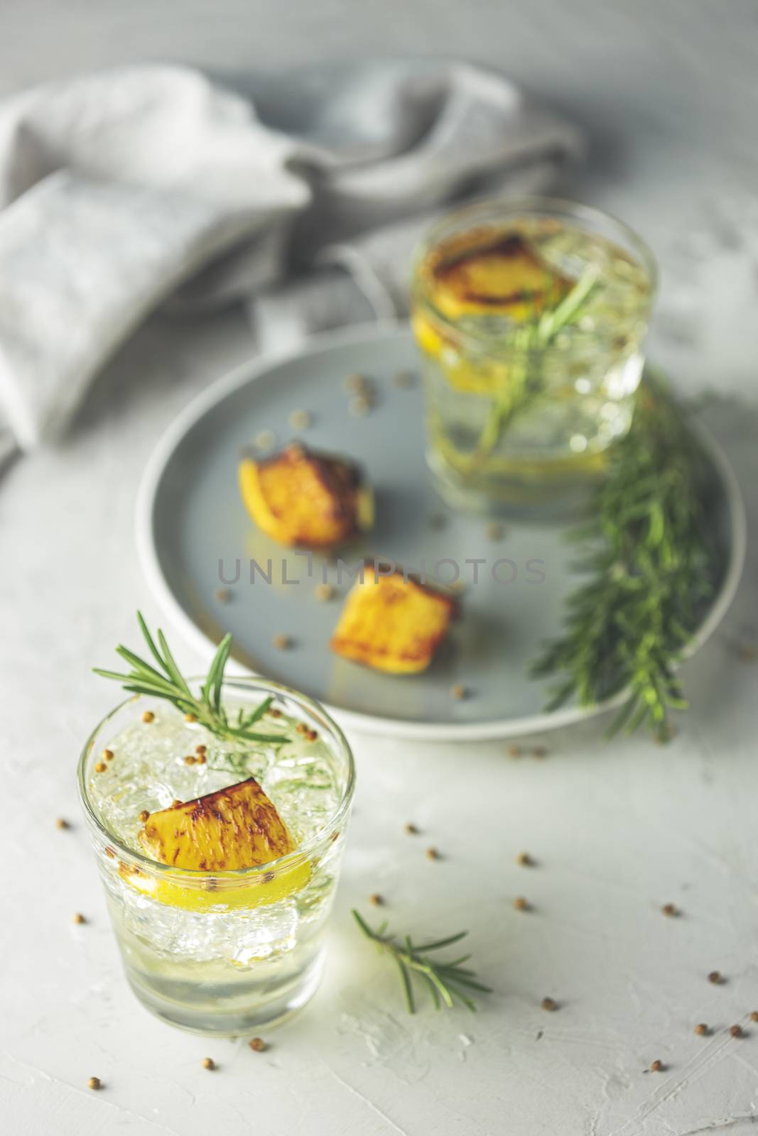 Two glasses of Charred Lemon, Rosemary and Coriander Gin and Ton by ArtSvitlyna