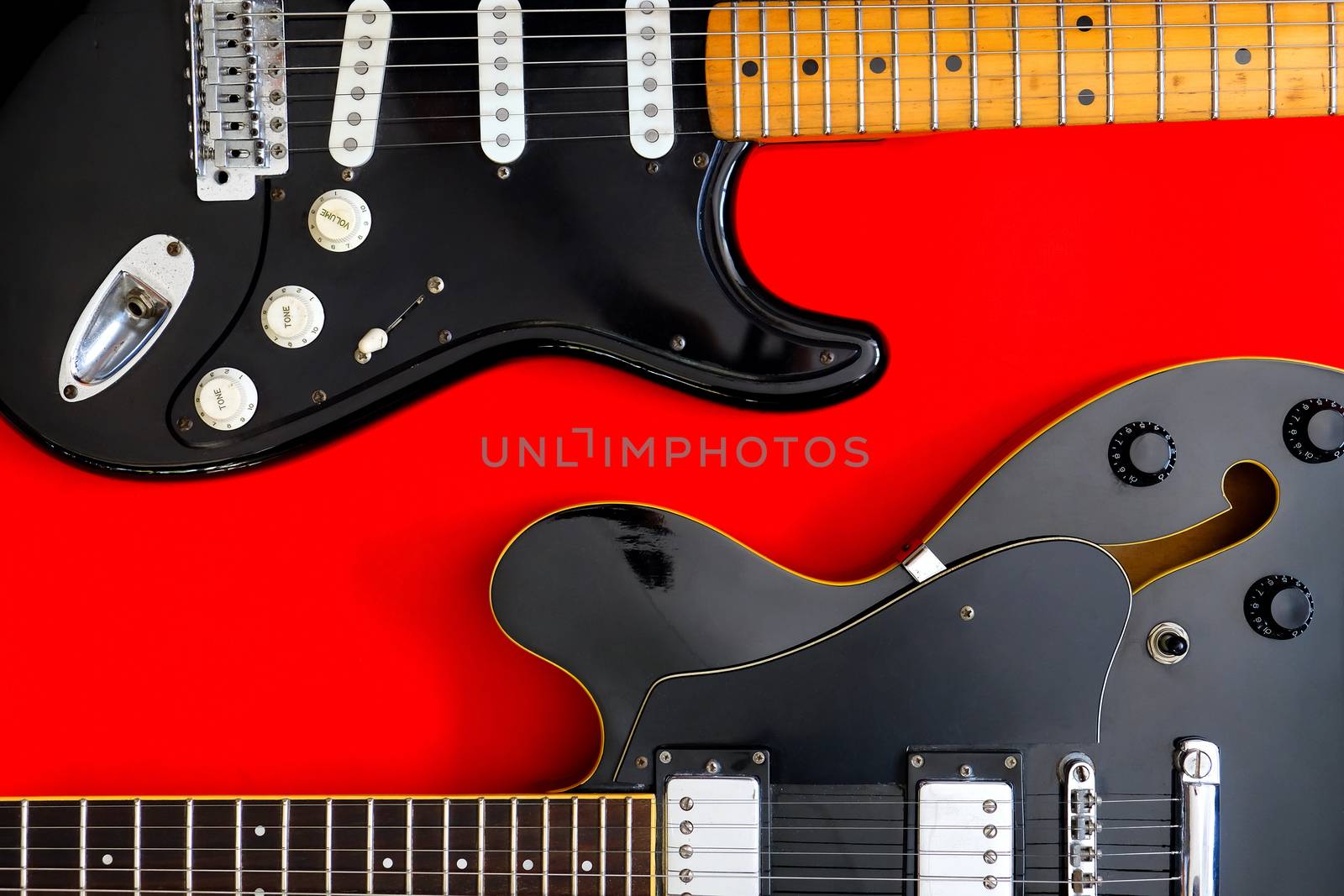 Detail of Electric Guitar on a red background.