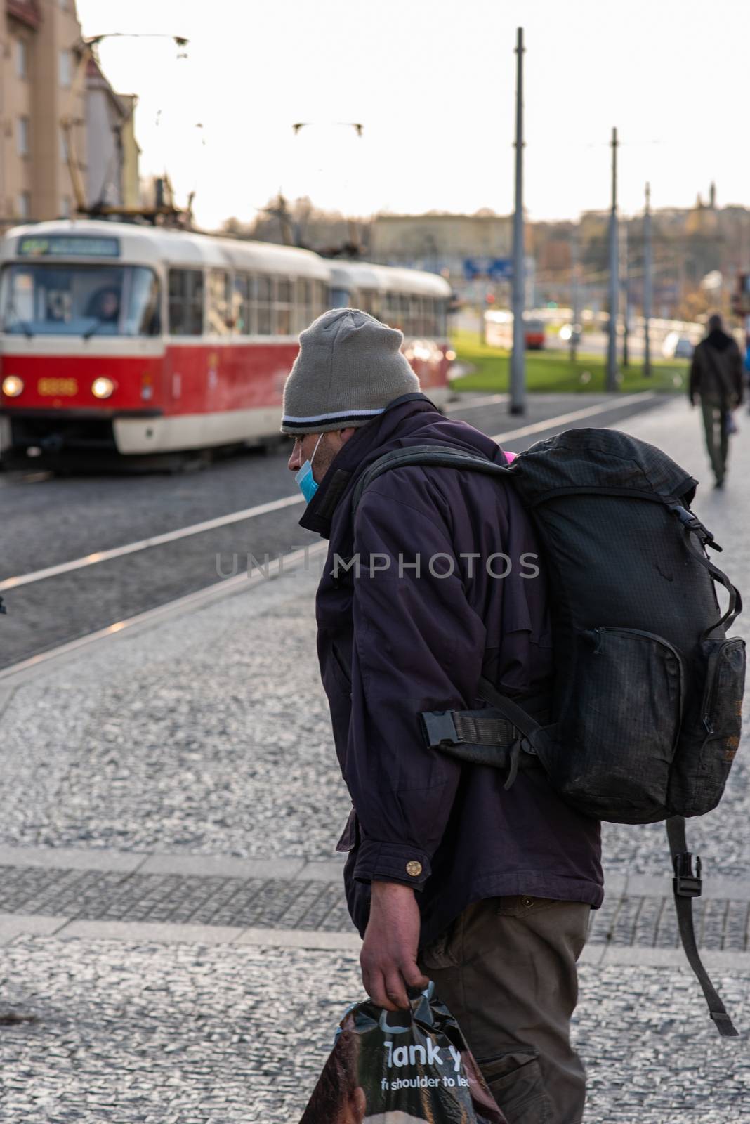 11-23-2020. Prague, Czech Republic. People walking and talking outside during coronavirus (COVID-19) at Hradcanska metro stop in Prague 6. Man walking with mask.
