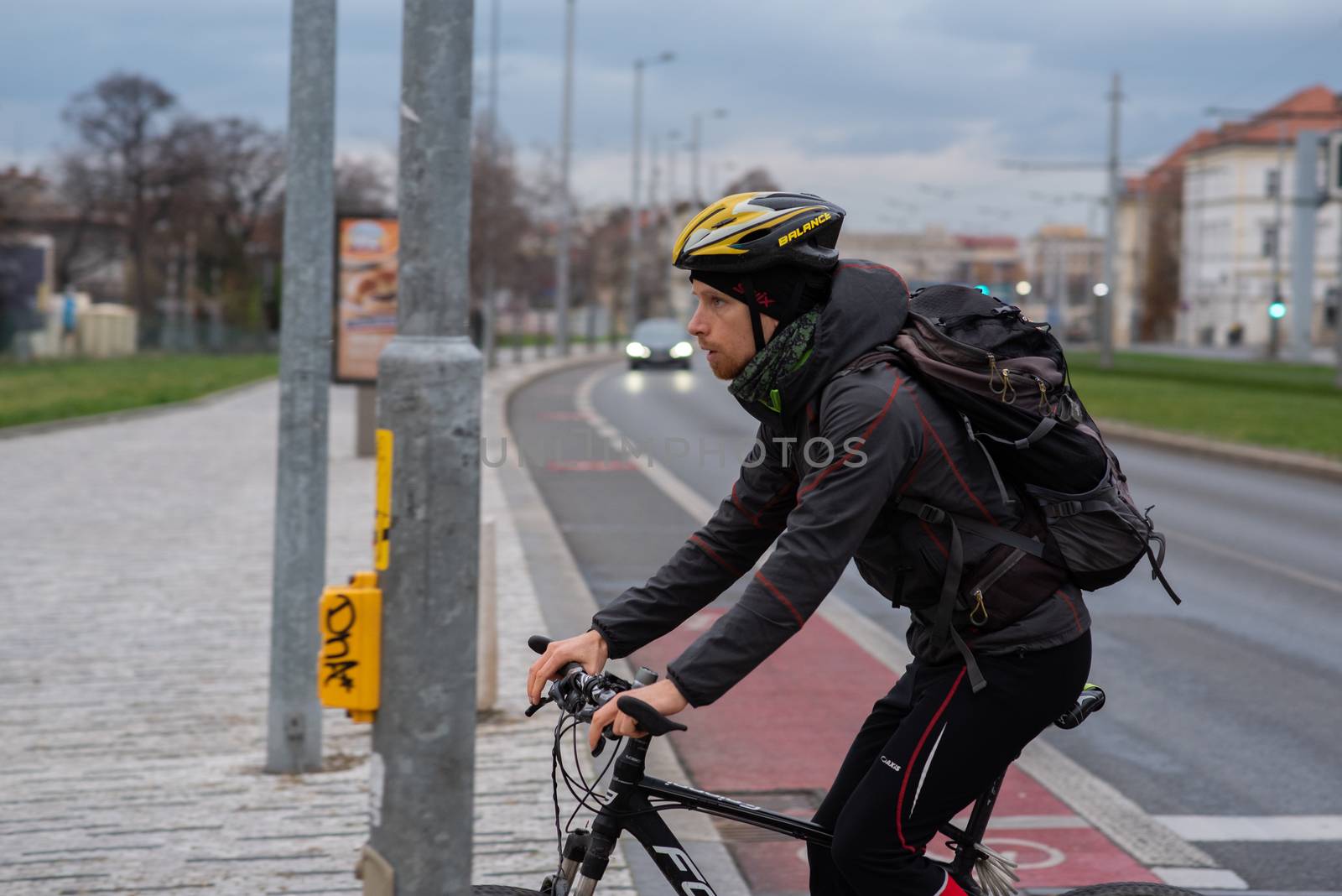 11-23-2020. Prague, Czech Republic. People walking and talking outside during coronavirus (COVID-19) at Hradcanska metro stop in Prague 6. Man in bike.