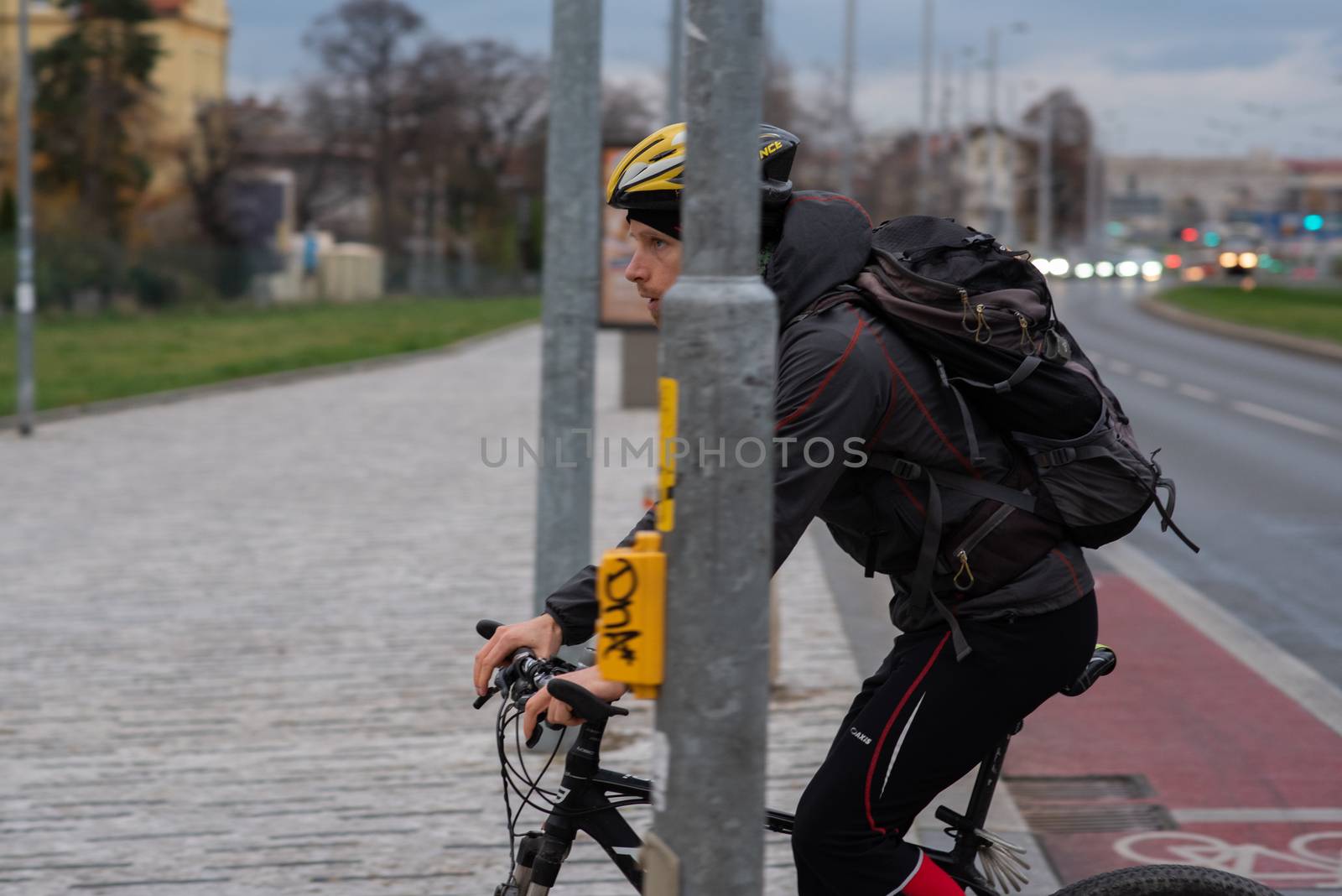 11-23-2020. Prague, Czech Republic. People walking and talking outside during coronavirus (COVID-19) at Hradcanska metro stop in Prague 6. Man in bike.