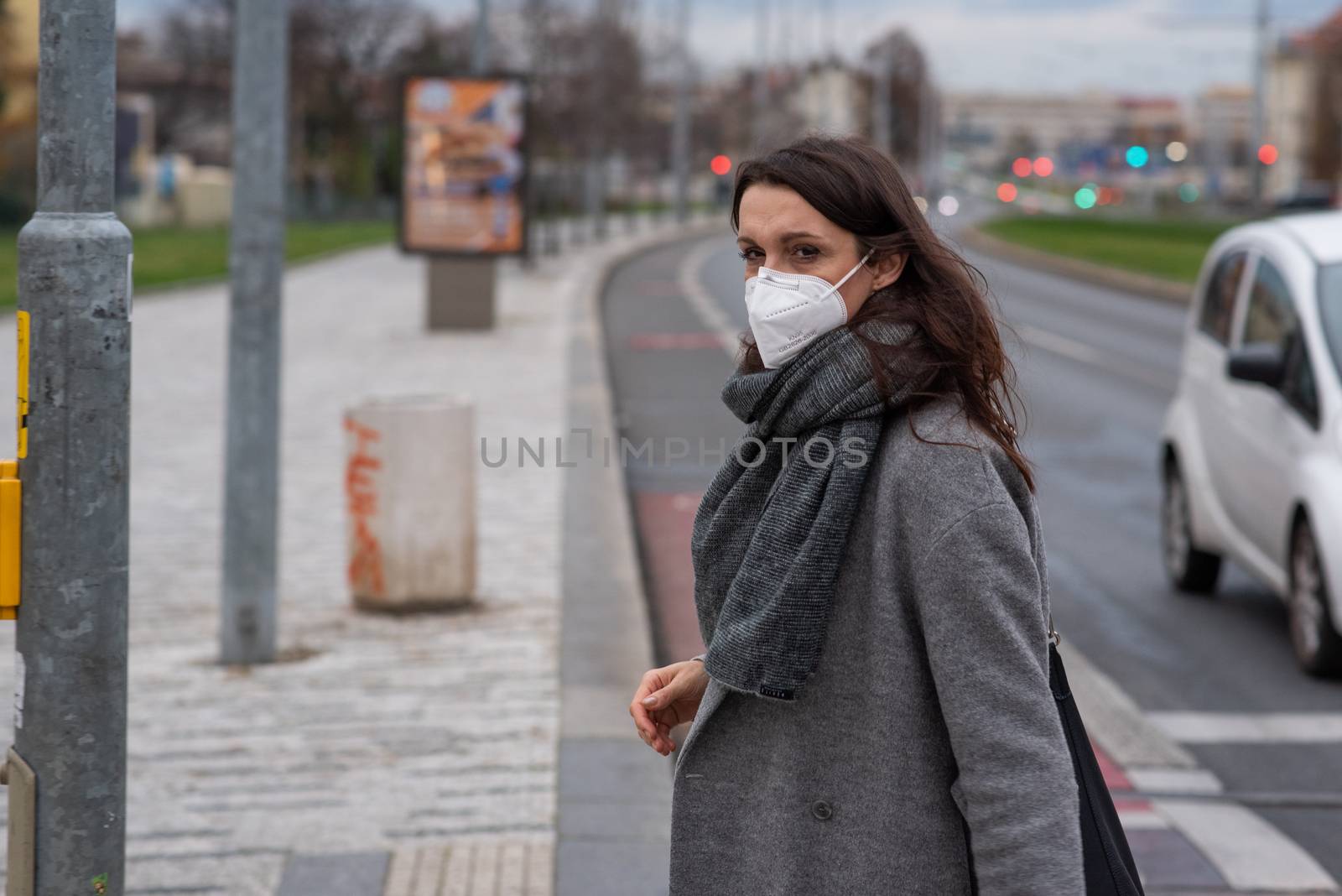 11-23-2020. Prague, Czech Republic. People walking and talking outside during coronavirus (COVID-19) at Hradcanska metro stop in Prague 6. Woman with mask.