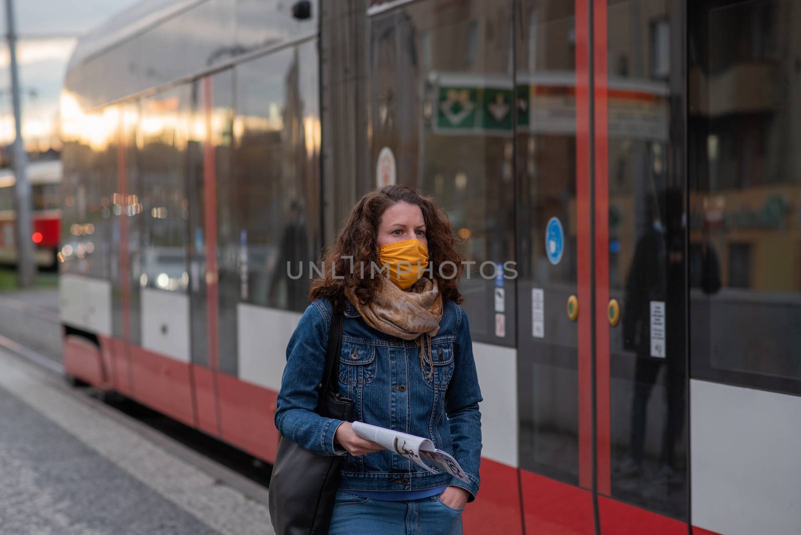 11-23-2020. Prague, Czech Republic. People walking and talking outside during coronavirus (COVID-19) at Hradcanska metro stop in Prague 6. Woman with mask waiting for pram..