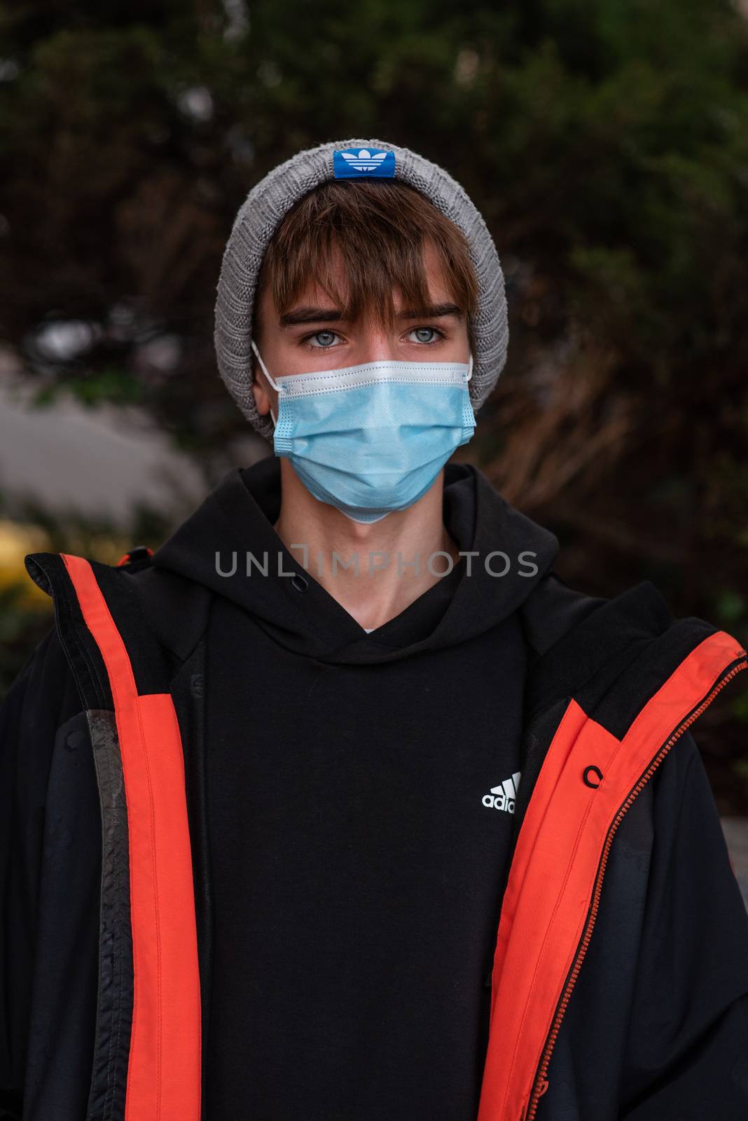 11-23-2020. Prague, Czech Republic. People walking and talking outside during coronavirus (COVID-19) at Hradcanska metro stop in Prague 6. Portrait of young man with mask.