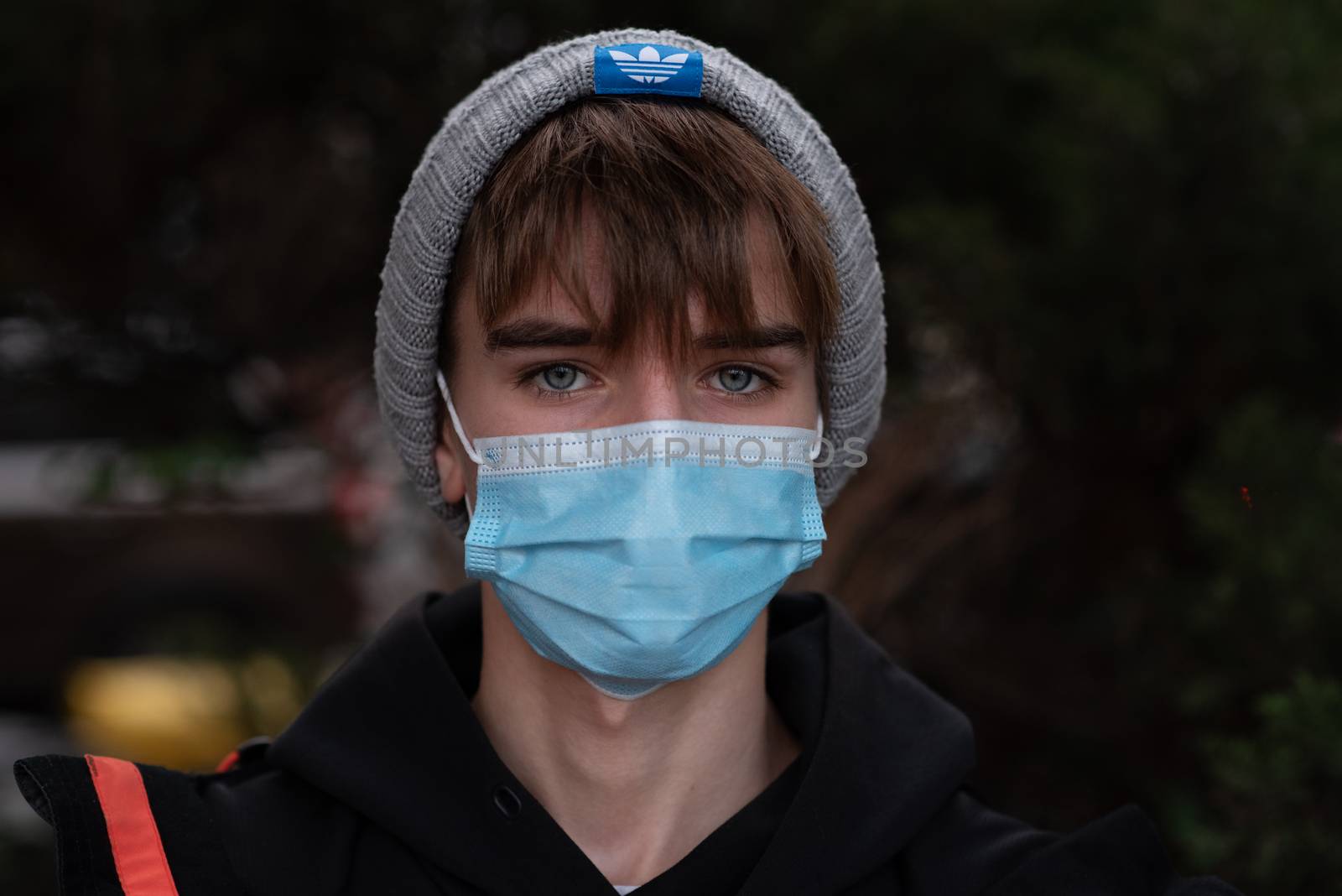 11-23-2020. Prague, Czech Republic. People walking and talking outside during coronavirus (COVID-19) at Hradcanska metro stop in Prague 6. Portrait of young man with mask.