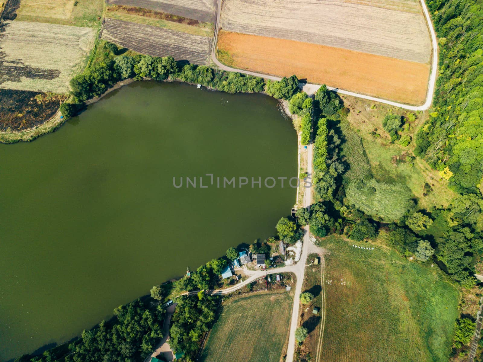 Aerial View Above Large Lake near Agricultural Fields. by TrEKone