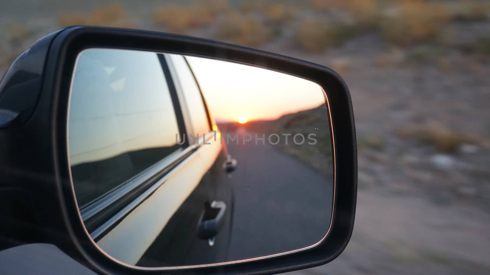 View in the side mirror of the car. by Passcal
