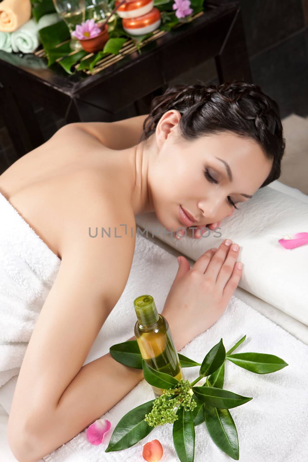 Young attractive woman taking massage and spa procedures